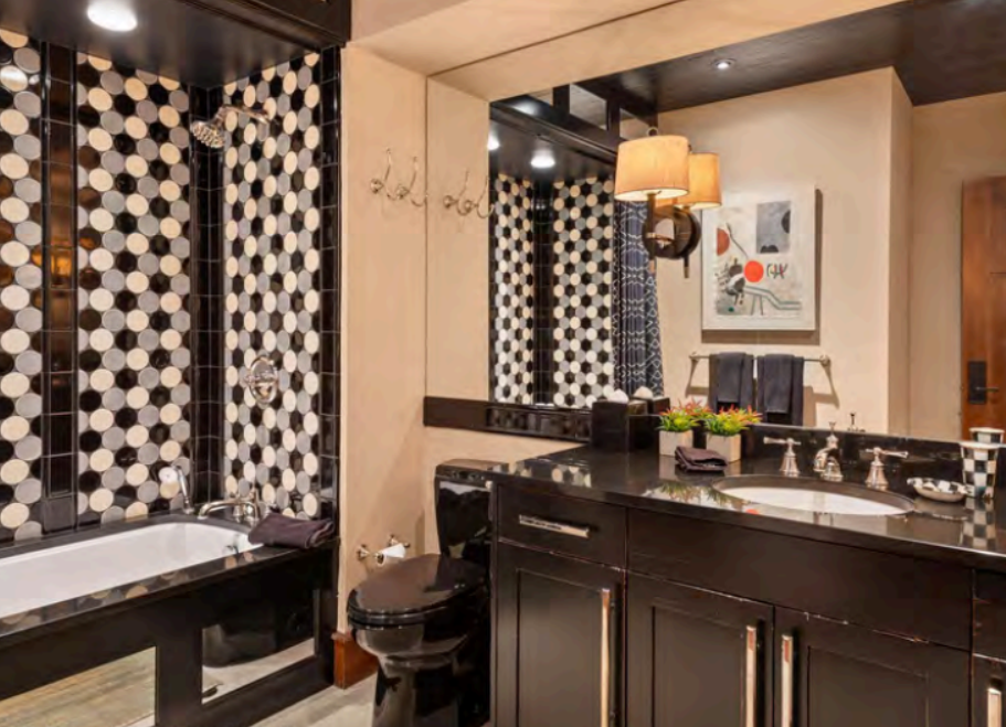 Stylish spa-like bathroom with soaking tub and bold designer tile