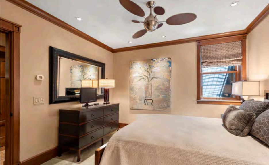 Cozy, elegant bedroom with warm wood accents and modern comforts