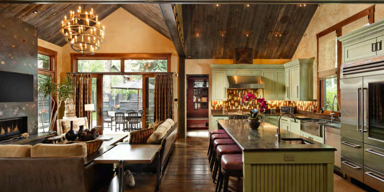 Warm open-concept great room with gourmet kitchen and vaulted ceilings