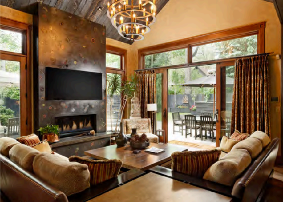 Stylish great room with fireplace, big windows, and patio access