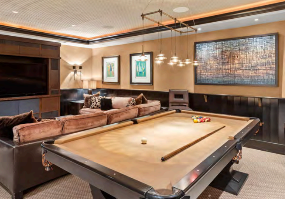 Stylish game room with pool table and cozy lounge seating
