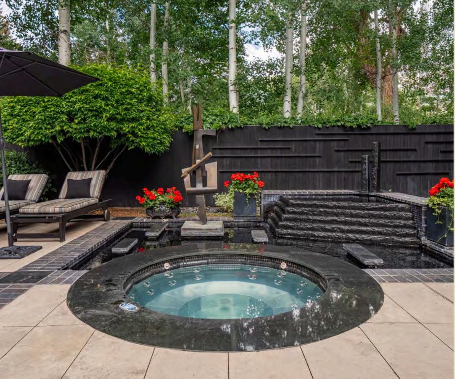 Private hot tub oasis with waterfall feature and serene lounge area