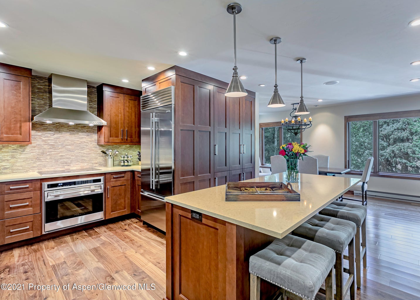 Gourmet kitchen with large island seating and open dining area