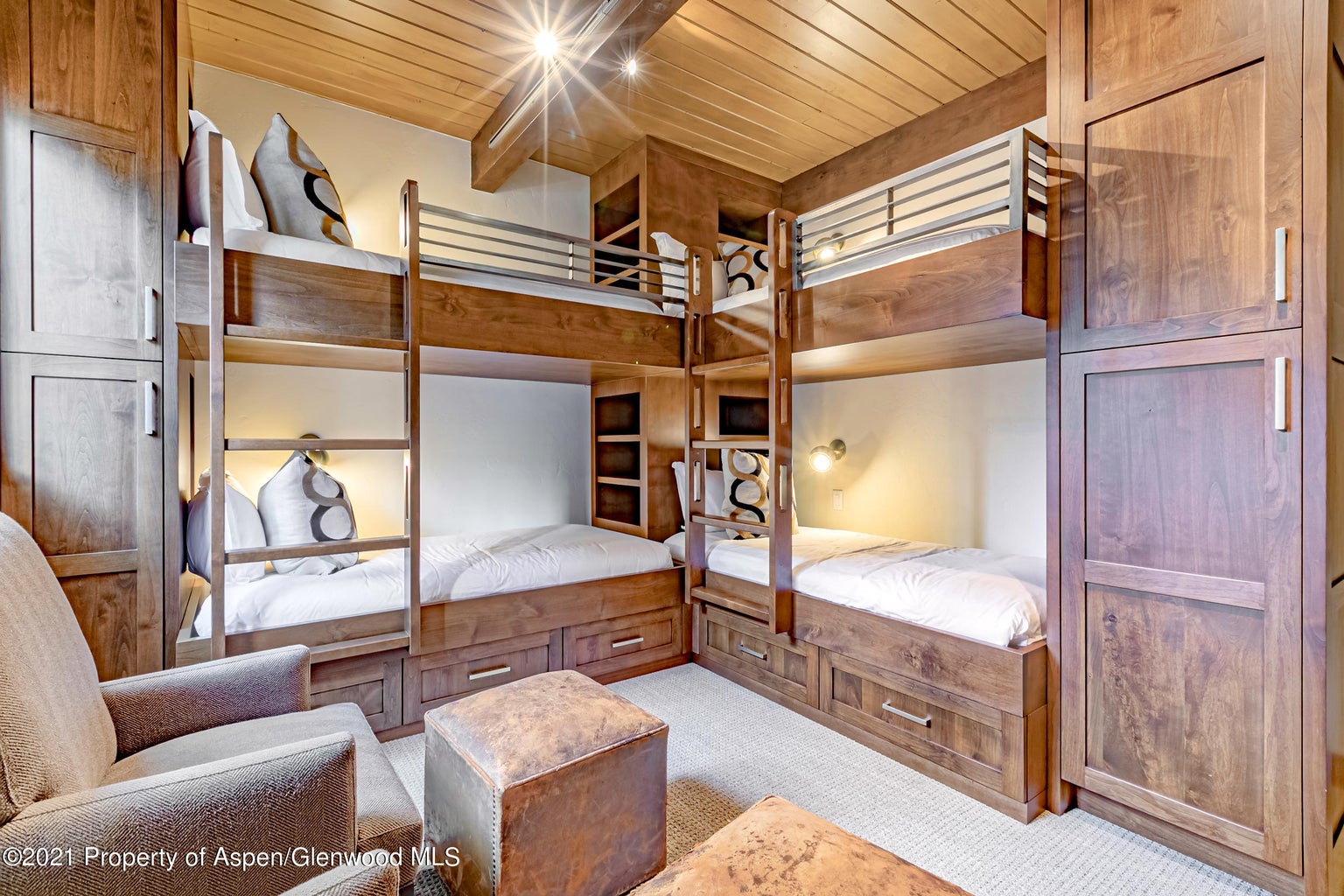 Custom built-in bunk room with warm wood finishes and smart storage