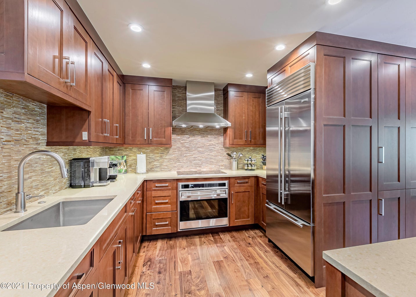 Upscale chef’s kitchen with stainless appliances and abundant storage