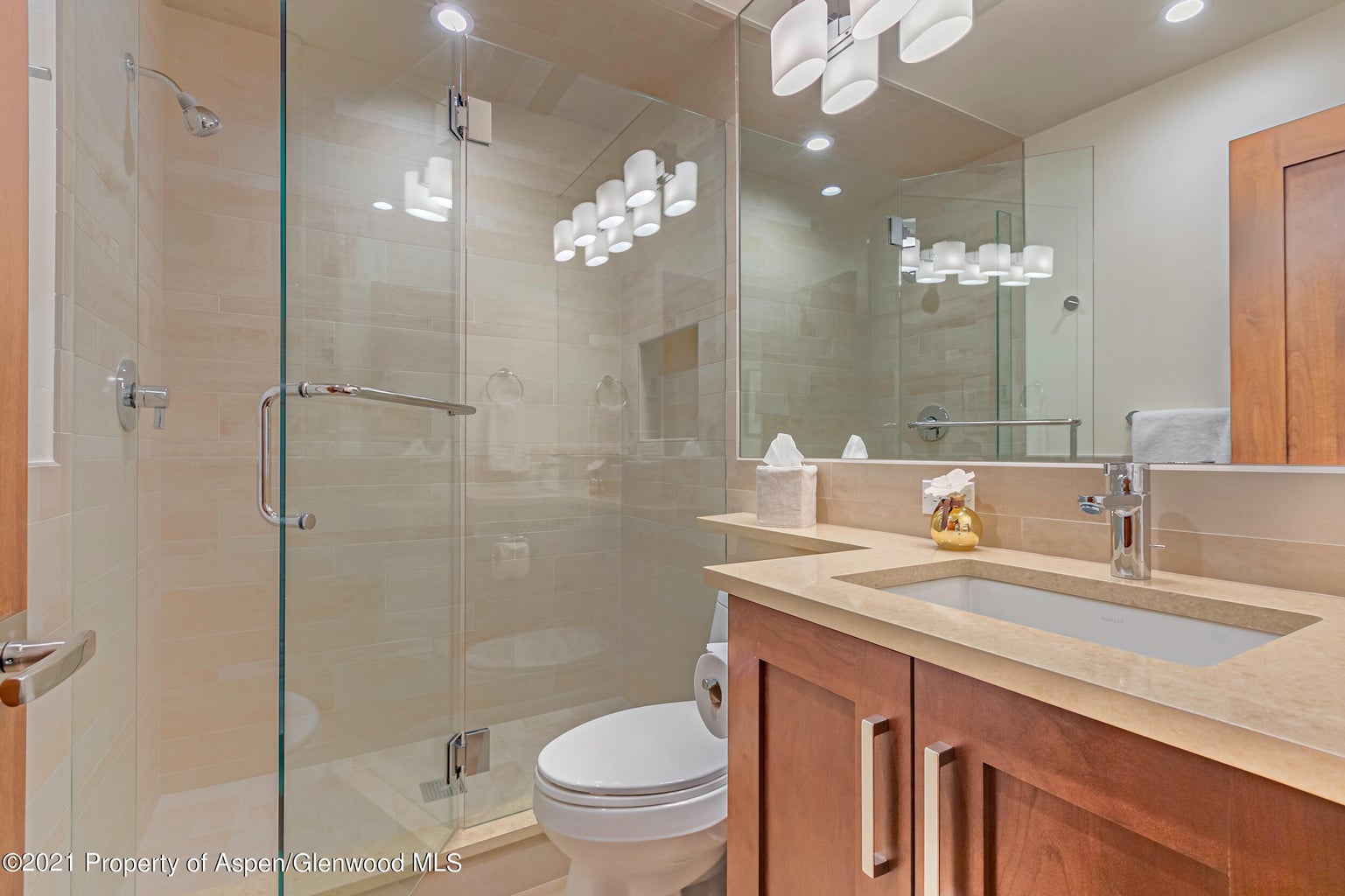 Modern spa-style bathroom with glass shower and spacious vanity