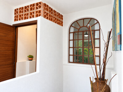 Bright hallway with arched window and charming terracotta details
