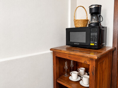 Convenient coffee station with microwave and charming wood cabinet