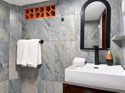 Modern tiled bathroom with sleek vanity and elegant black accents