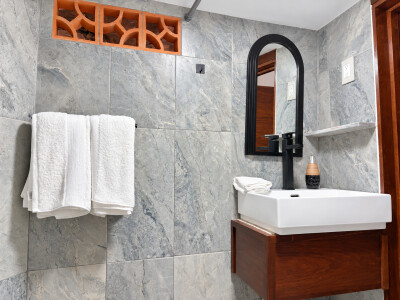 Modern tiled bathroom with sleek vanity and elegant black accents