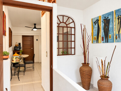 Bright entryway with charming décor, arched details, and cozy dining nook