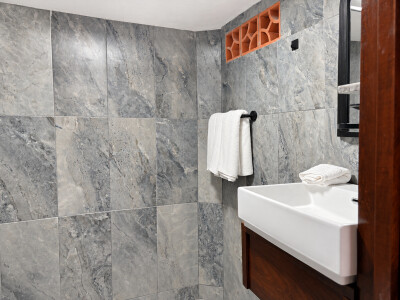 Modern tiled bathroom with sleek sink and fresh spa-like touches
