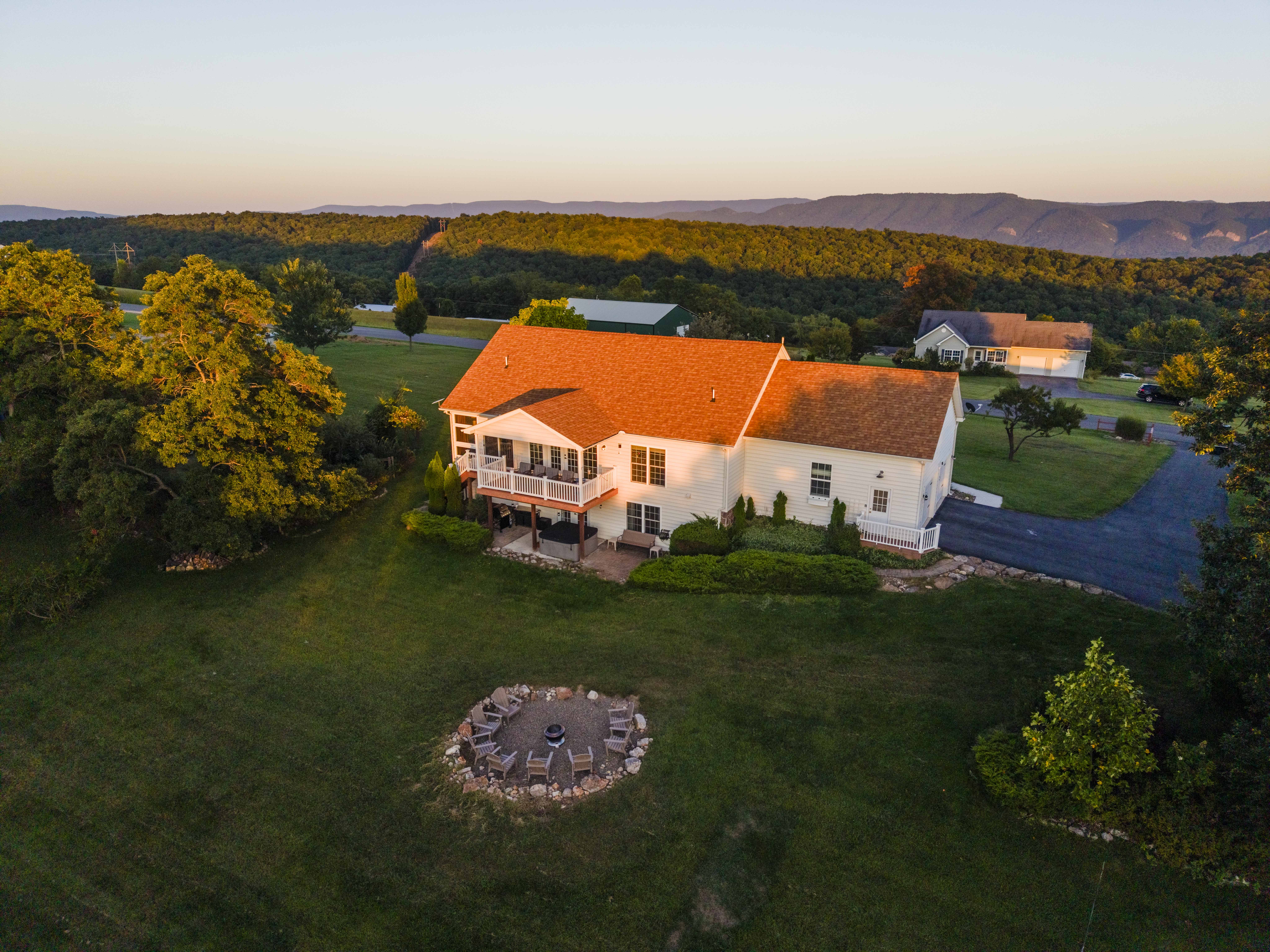 Scenic mountain retreat with expansive lawn, deck, and fire pit