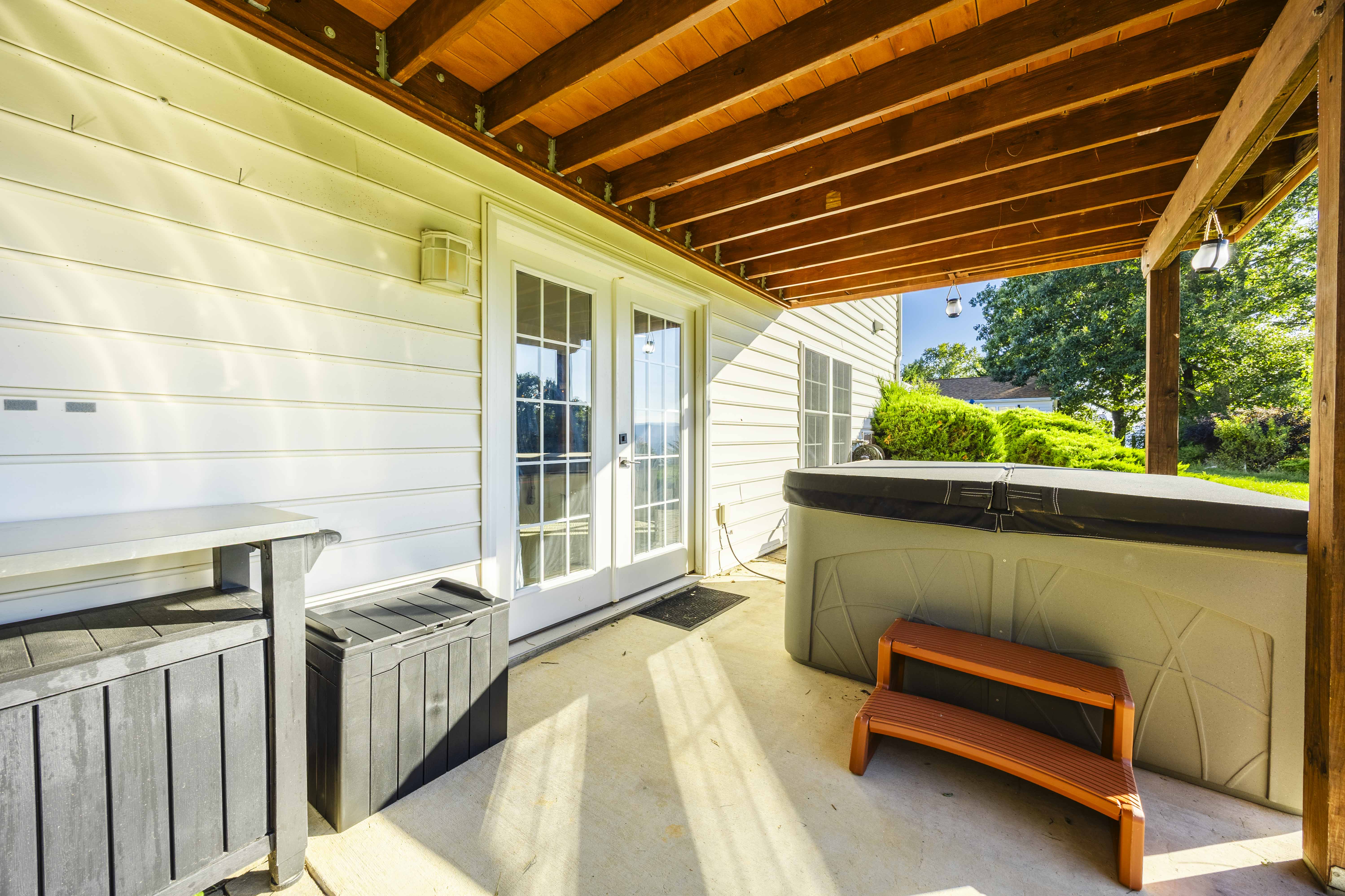 Covered patio with private hot tub and relaxing outdoor space