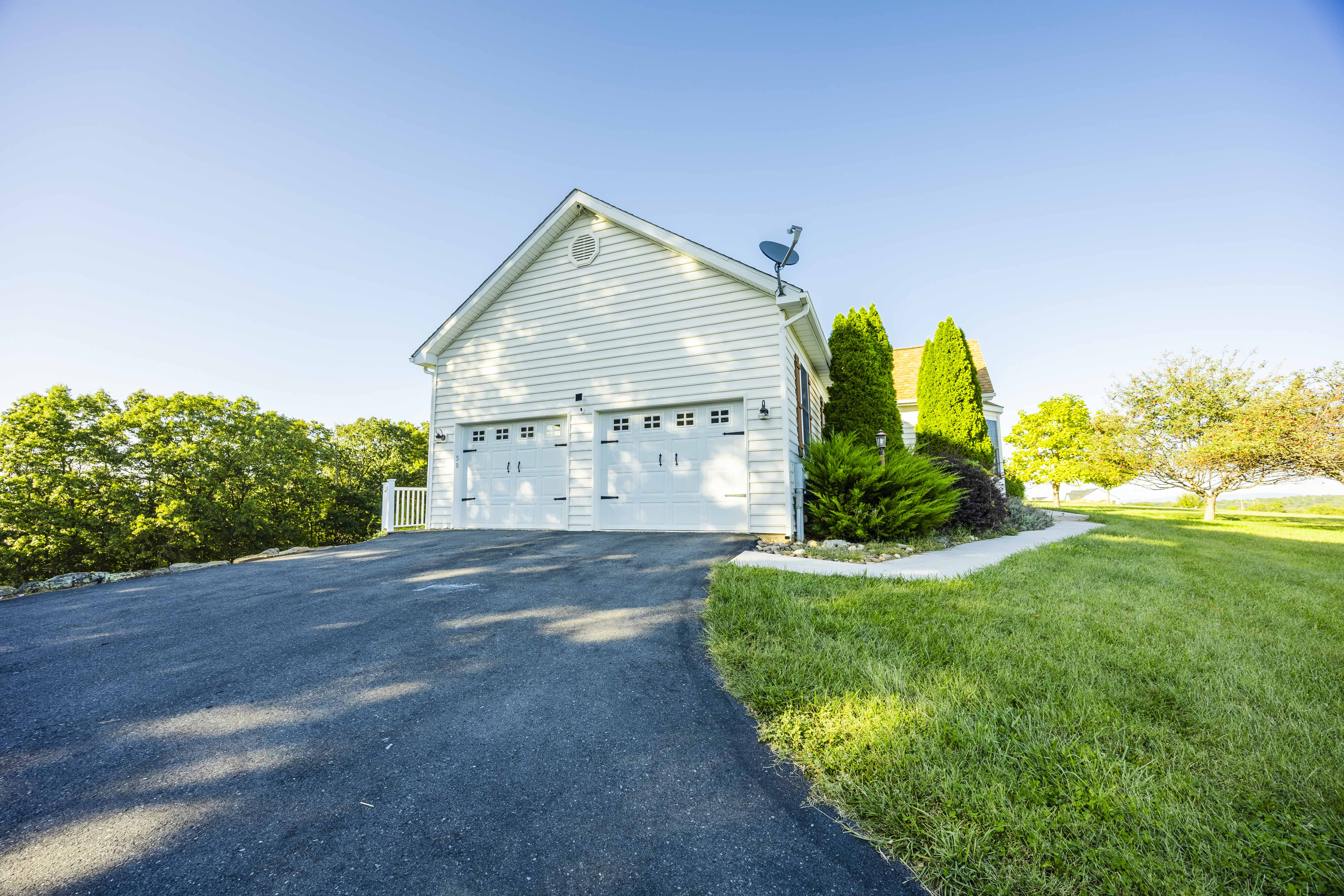 Spacious driveway, two-car garage, and beautifully landscaped grounds