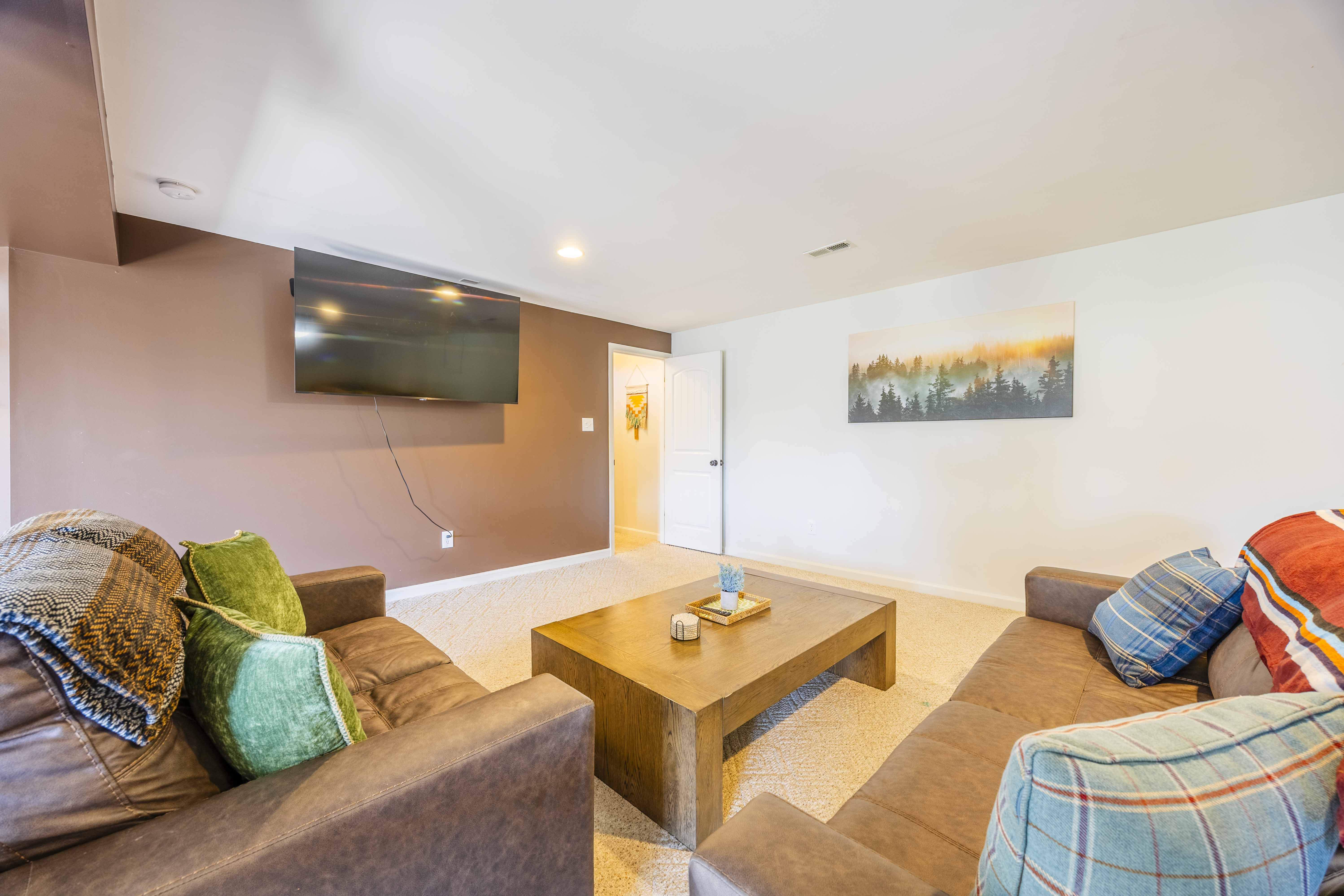 Cozy lounge with plush seating and wall-mounted TV for relaxing nights