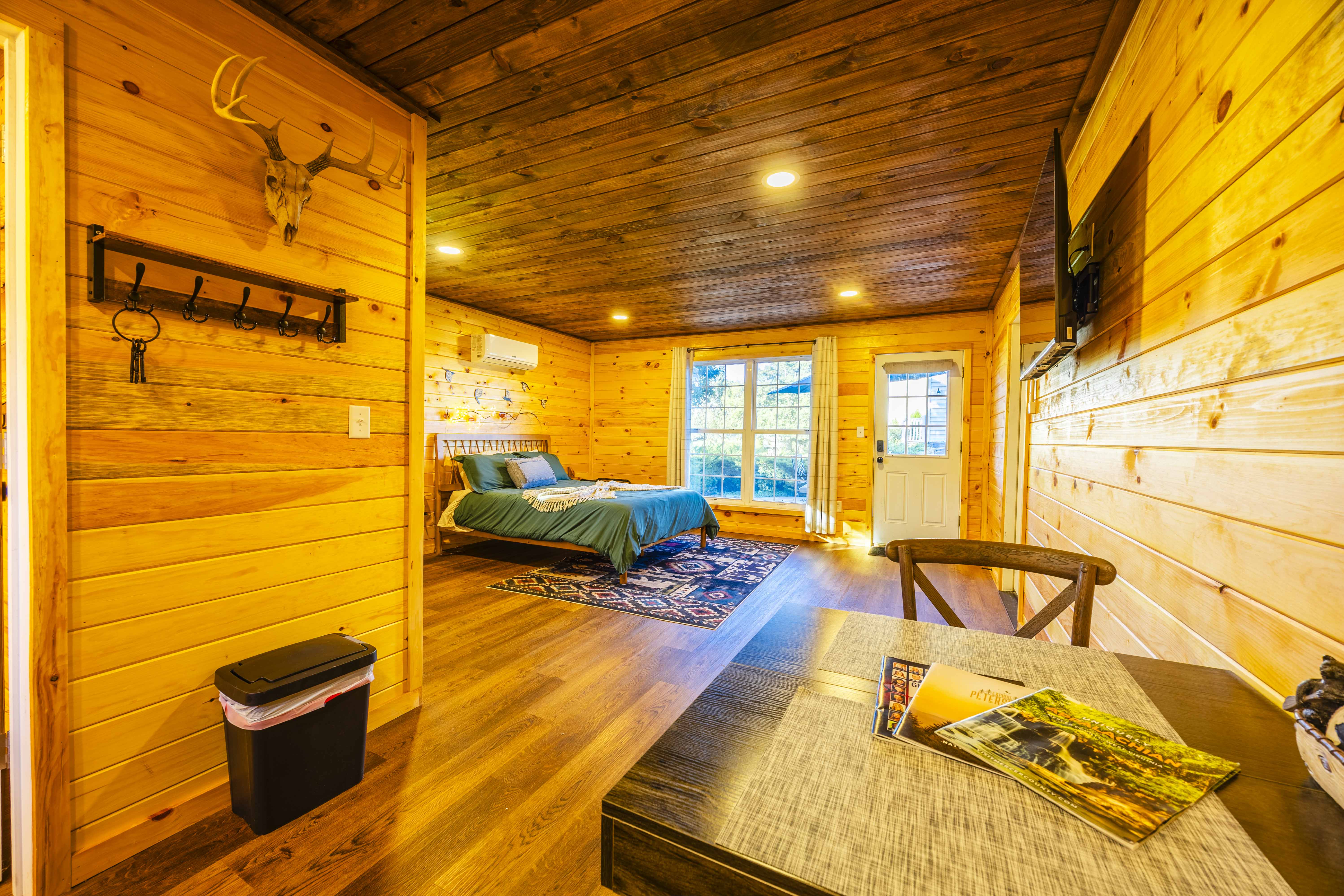 Cozy cabin-style suite with wood interiors, TV, and private entry
