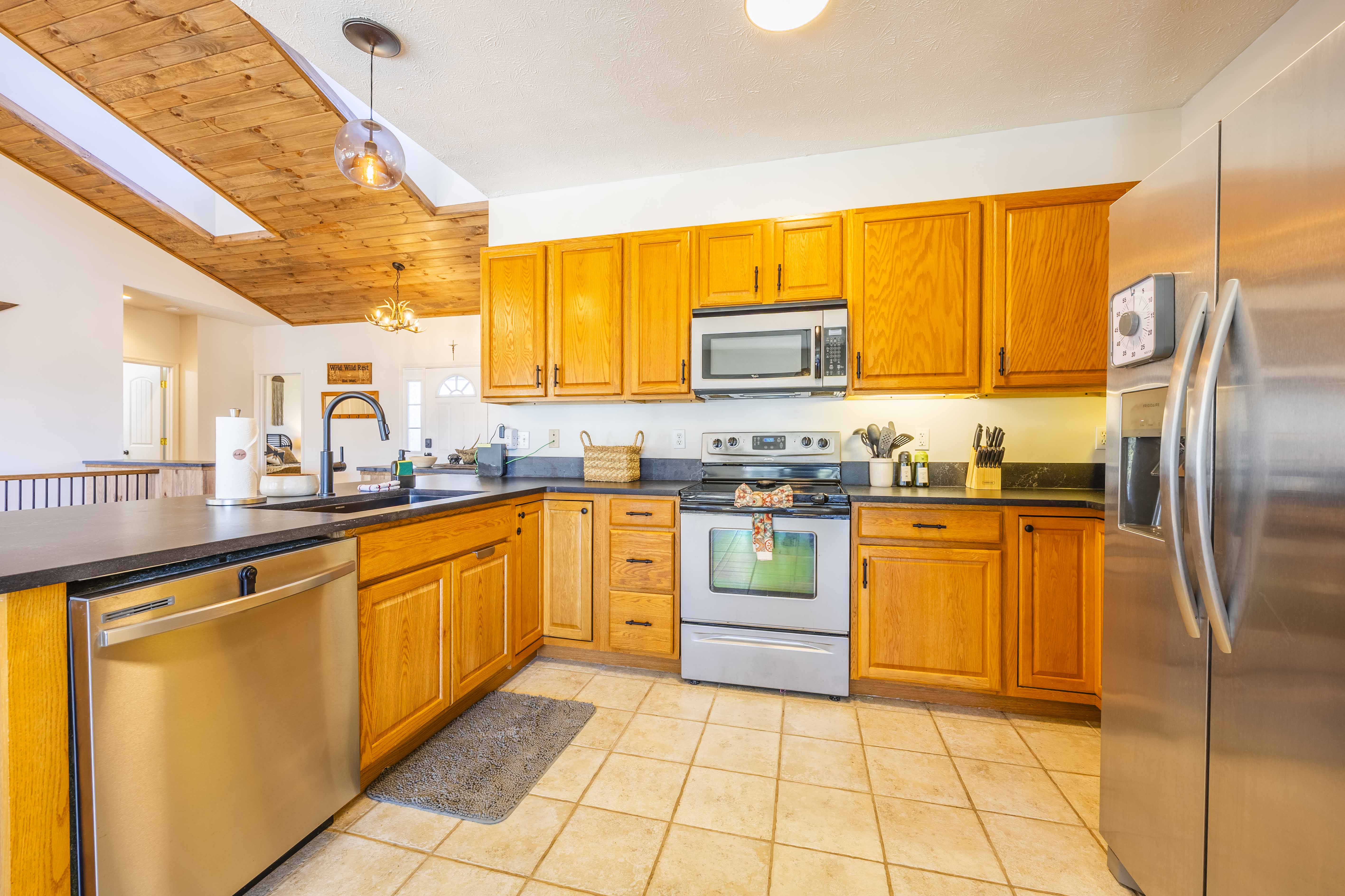 Bright open kitchen with stainless appliances and rustic wood accents
