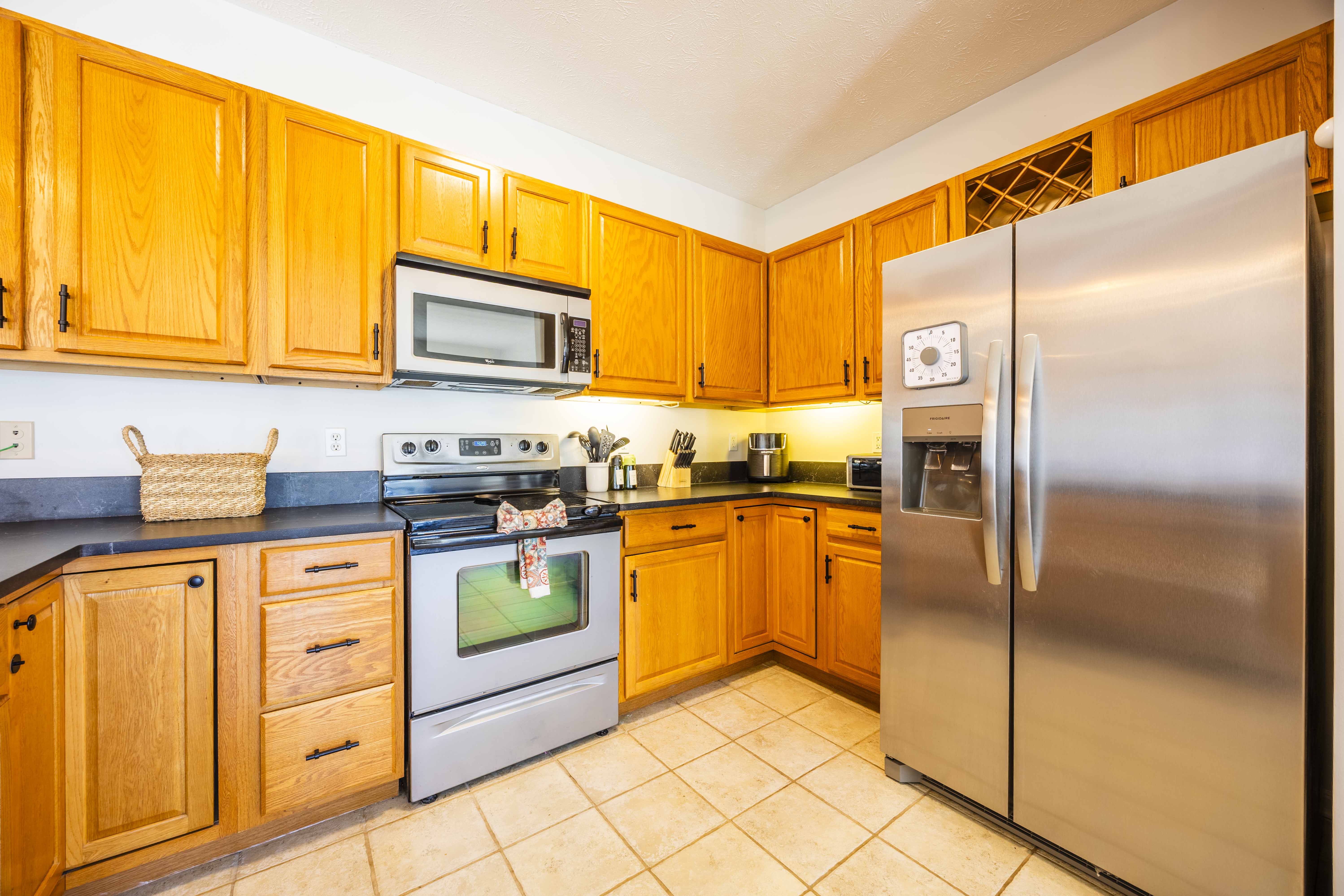 Bright full kitchen with stainless appliances and ample cabinet space
