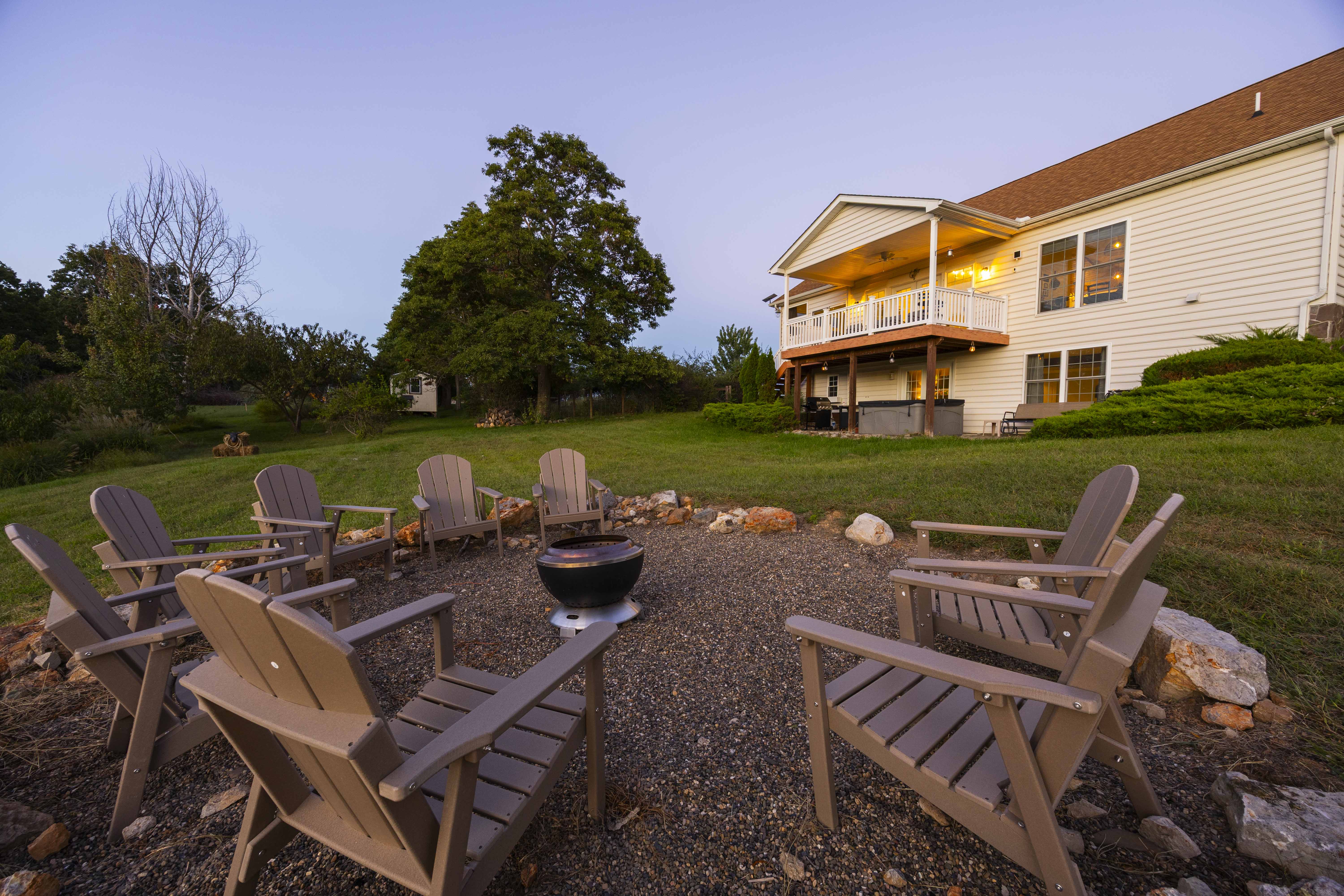 Cozy backyard fire pit with Adirondack seating and a glowing deck