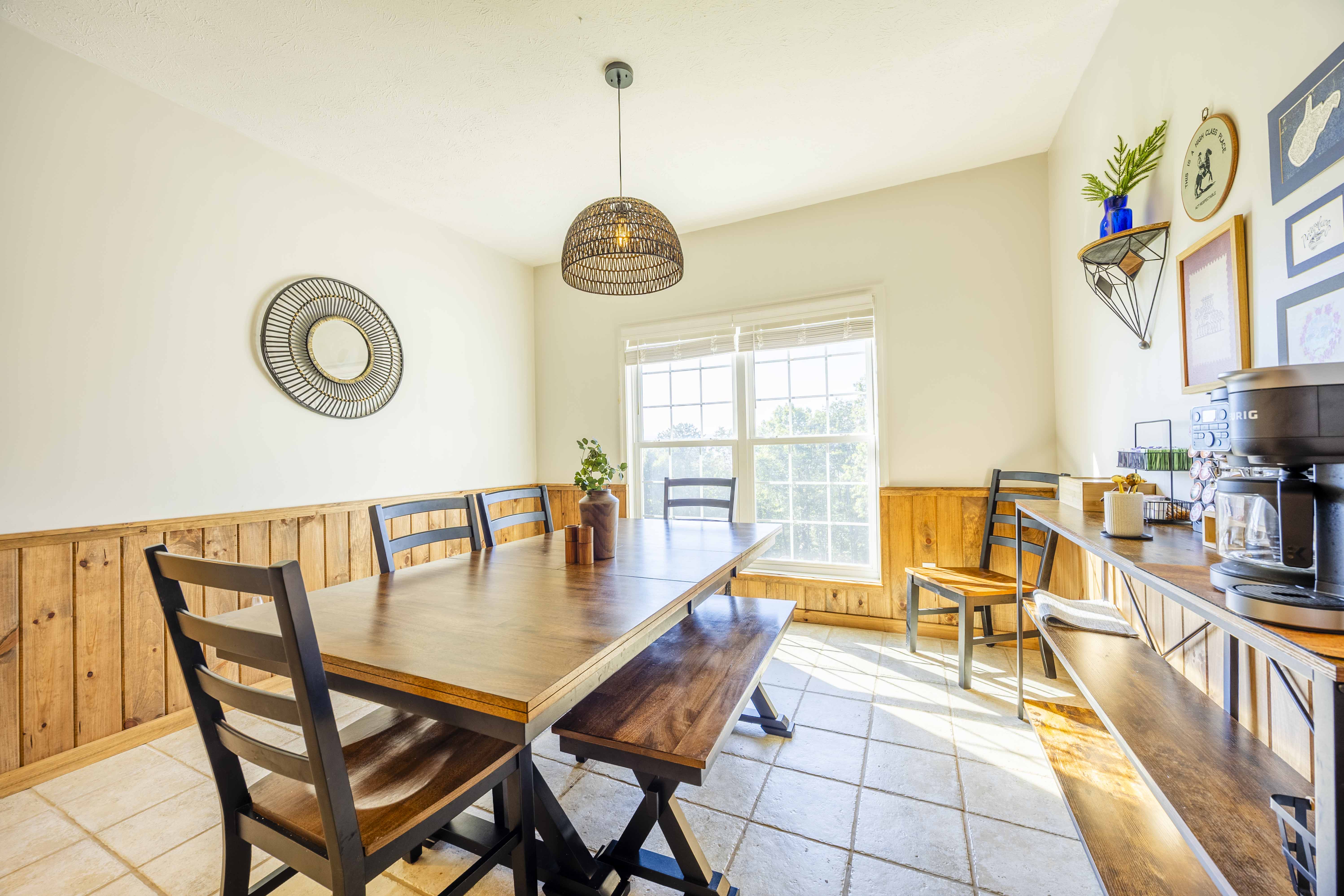 Sunny dining nook with rustic table, bench seating, and coffee station