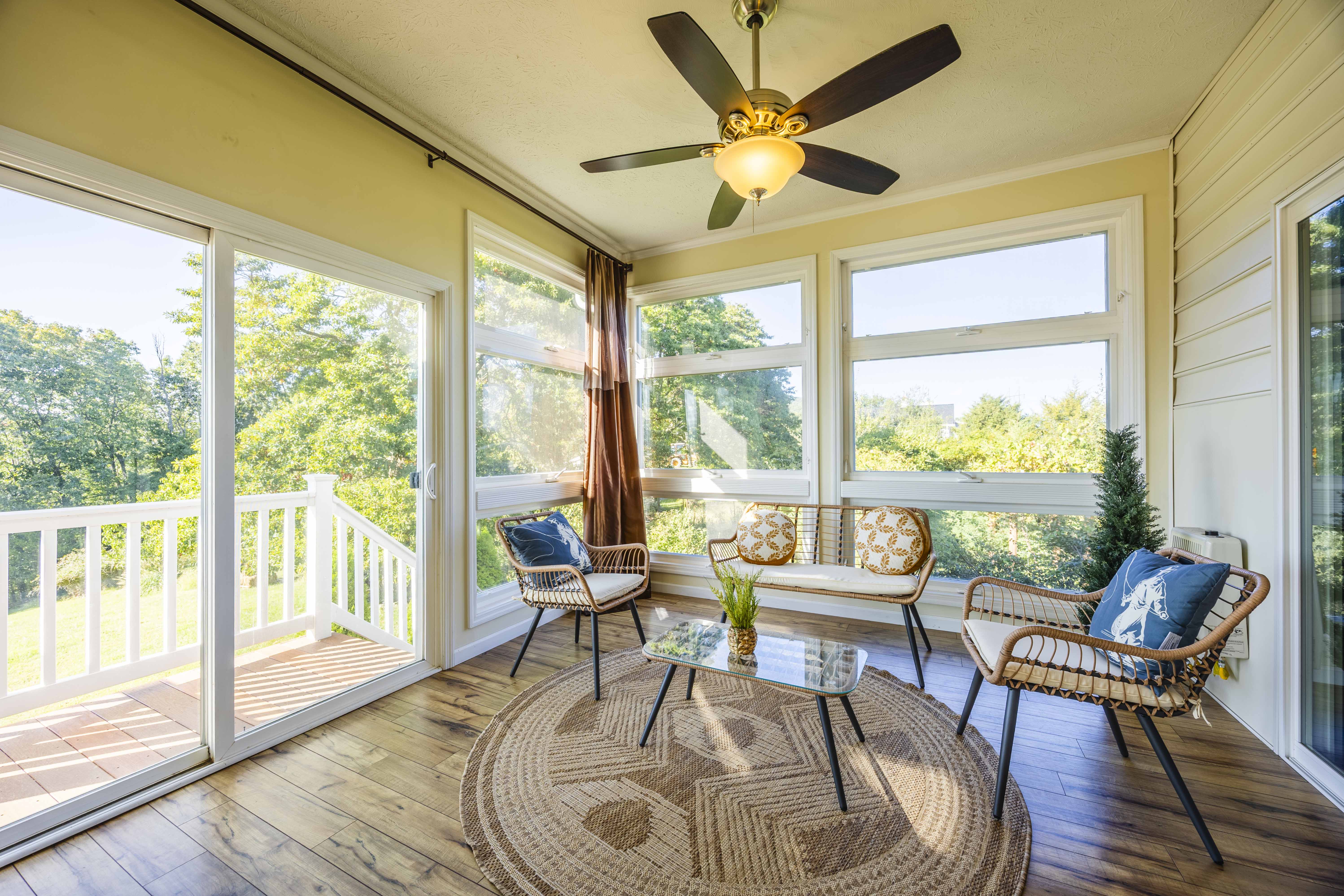 Sunny window-filled lounge with deck access and peaceful nature views