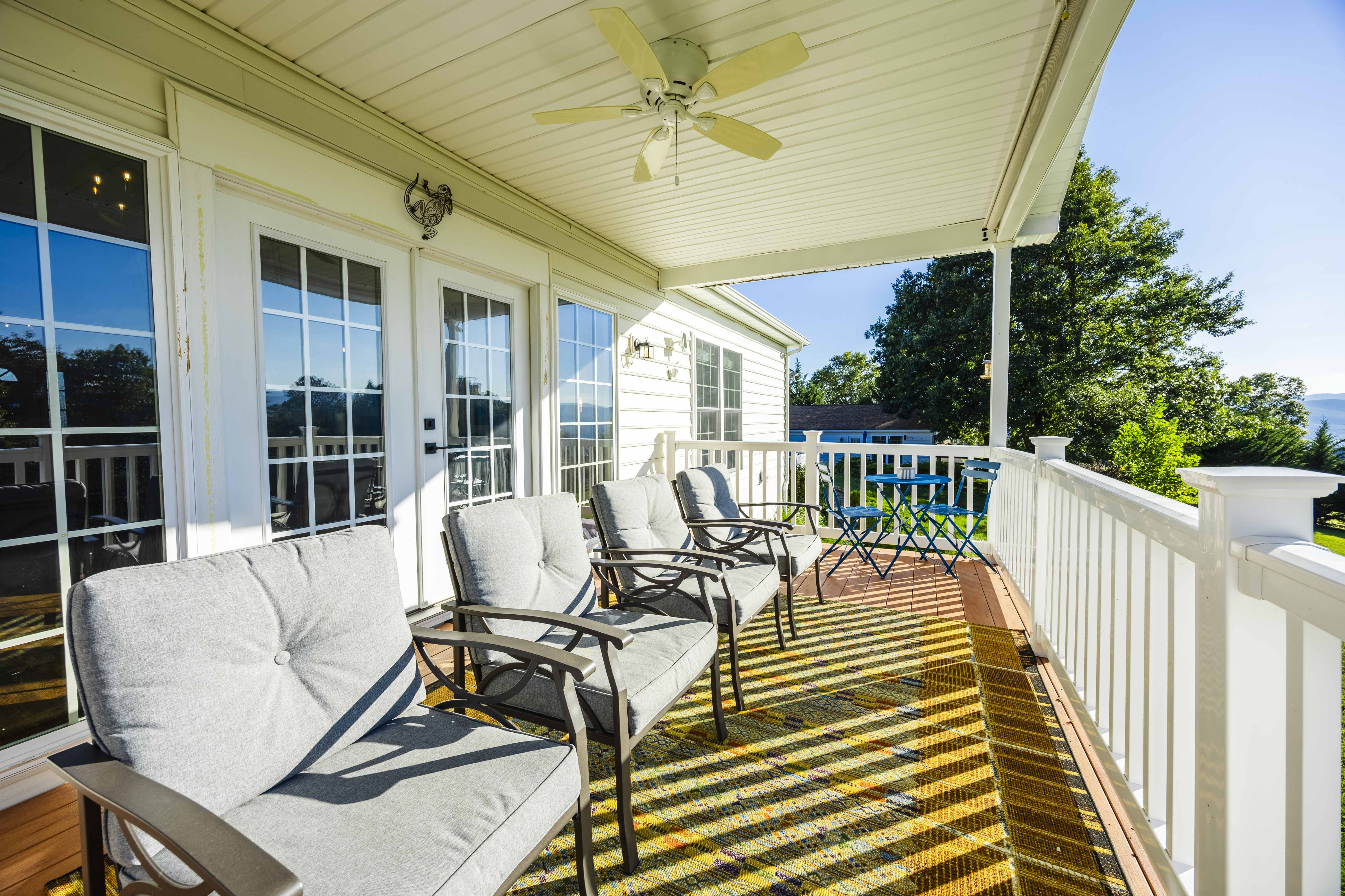Sunny covered balcony with cushioned seating and relaxing outdoor views