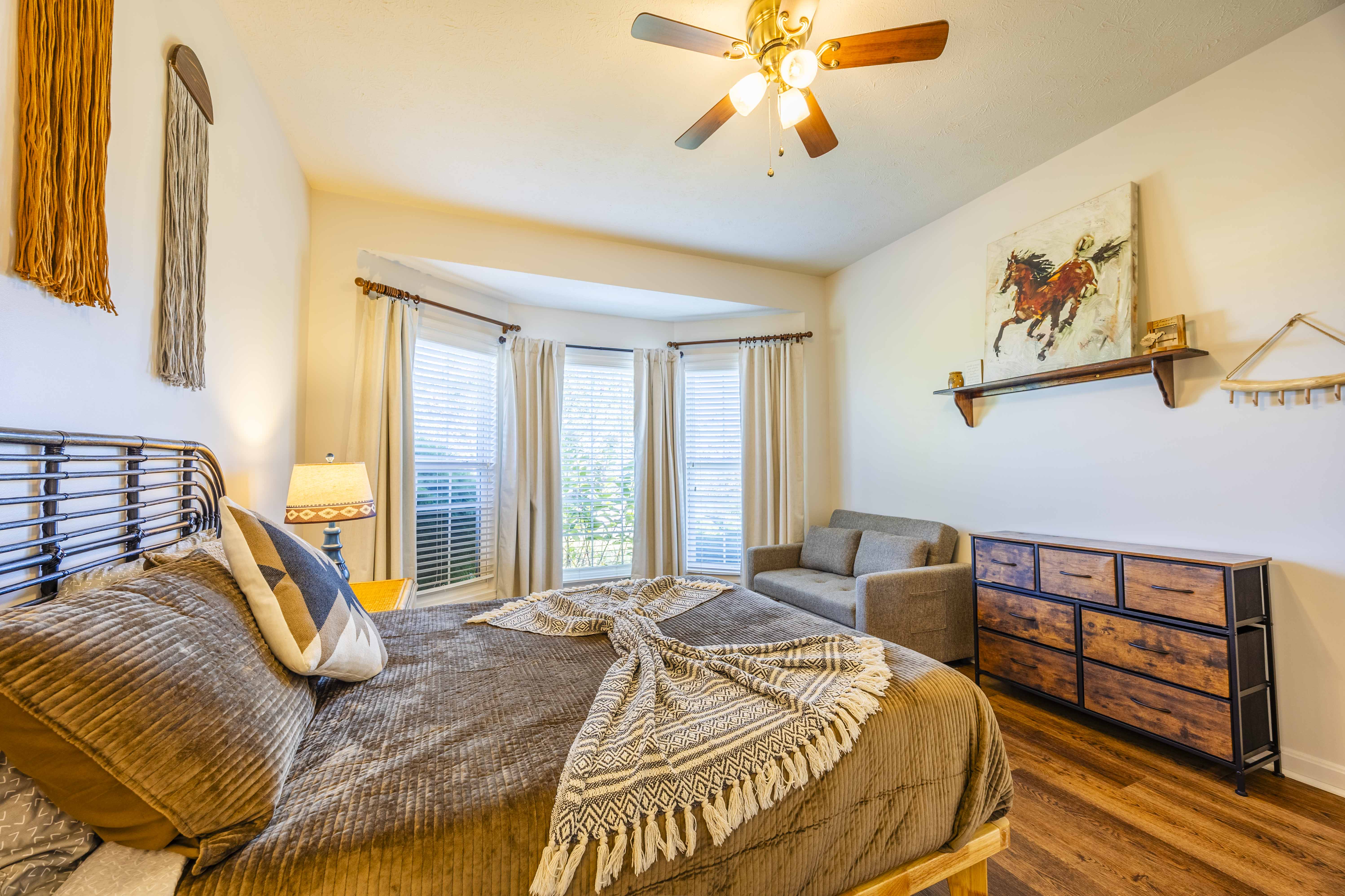 Bright, cozy bedroom with bay windows and stylish rustic touches