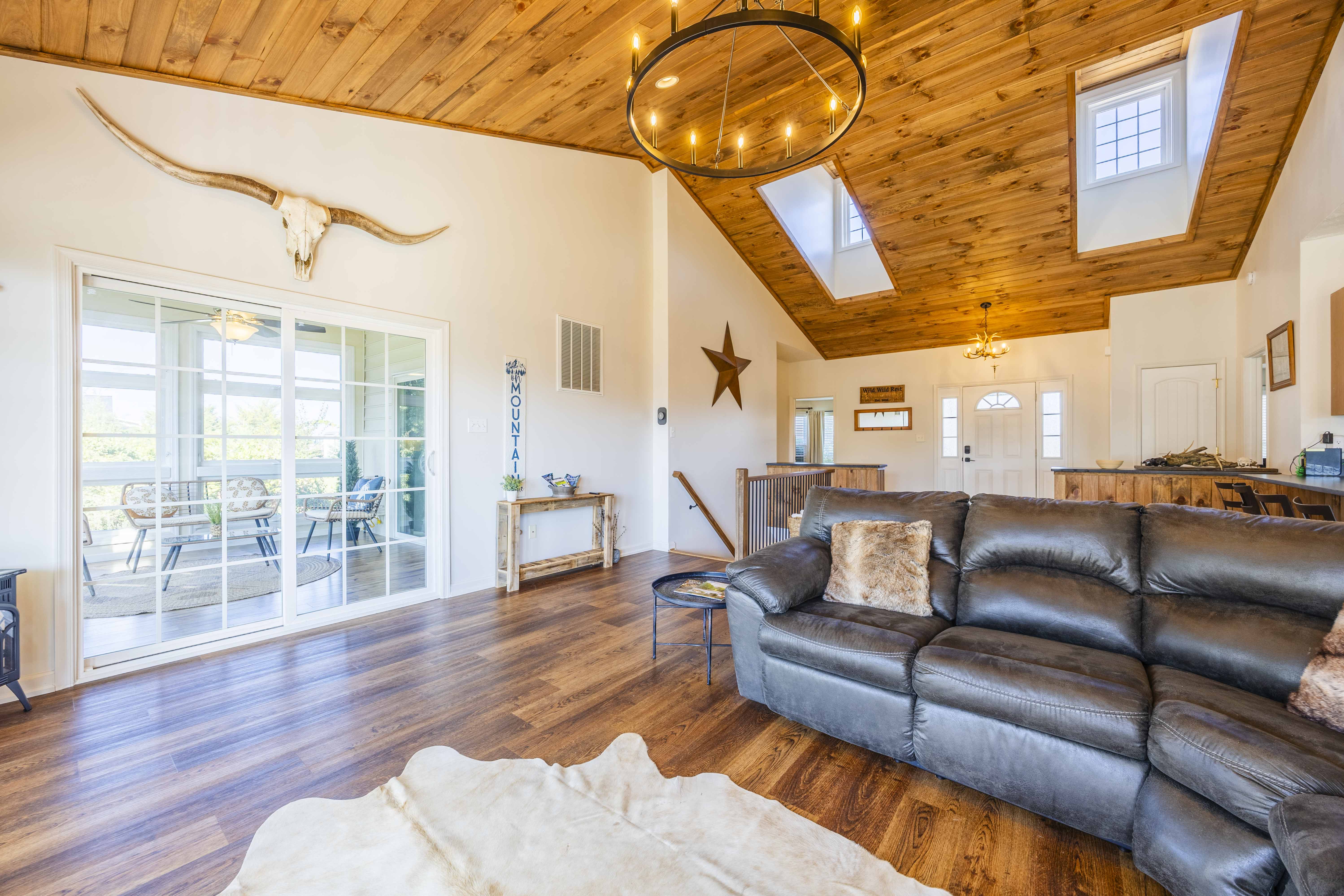 Vaulted wood ceilings, skylights & cozy seating with patio access
