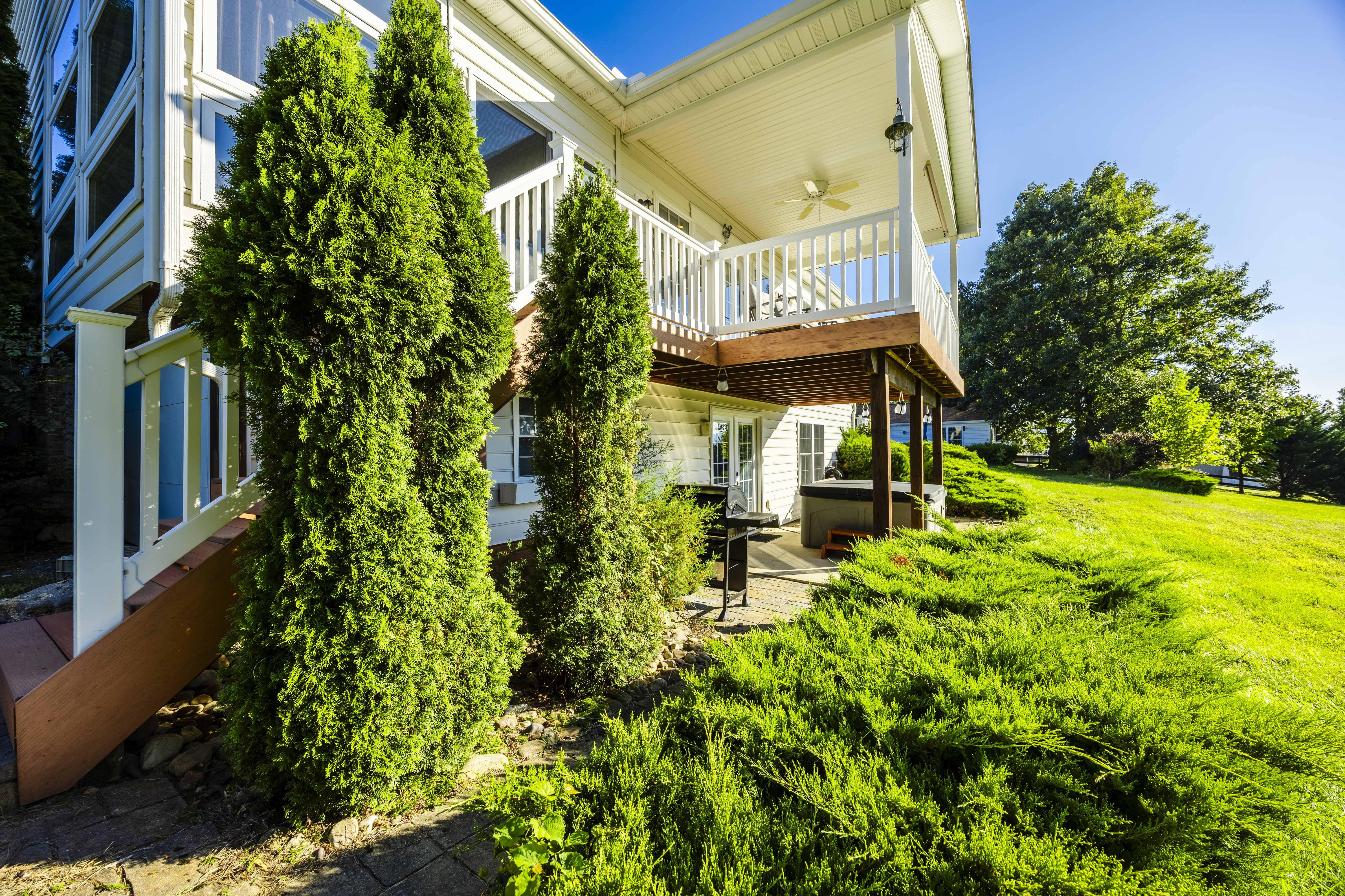 Spacious covered deck and lush private yard for outdoor relaxation