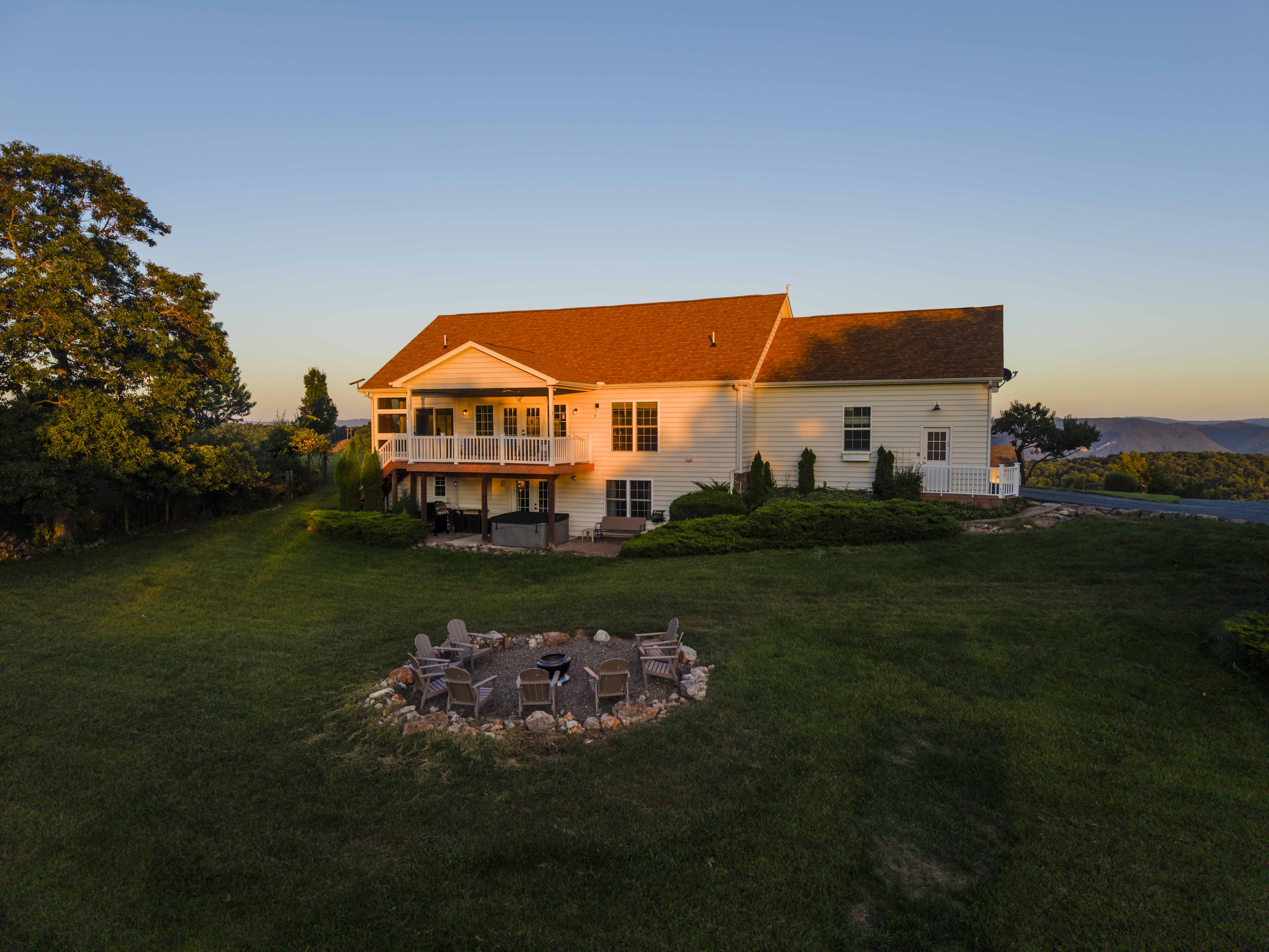 Golden-hour country retreat with deck, big yard, and cozy fire pit
