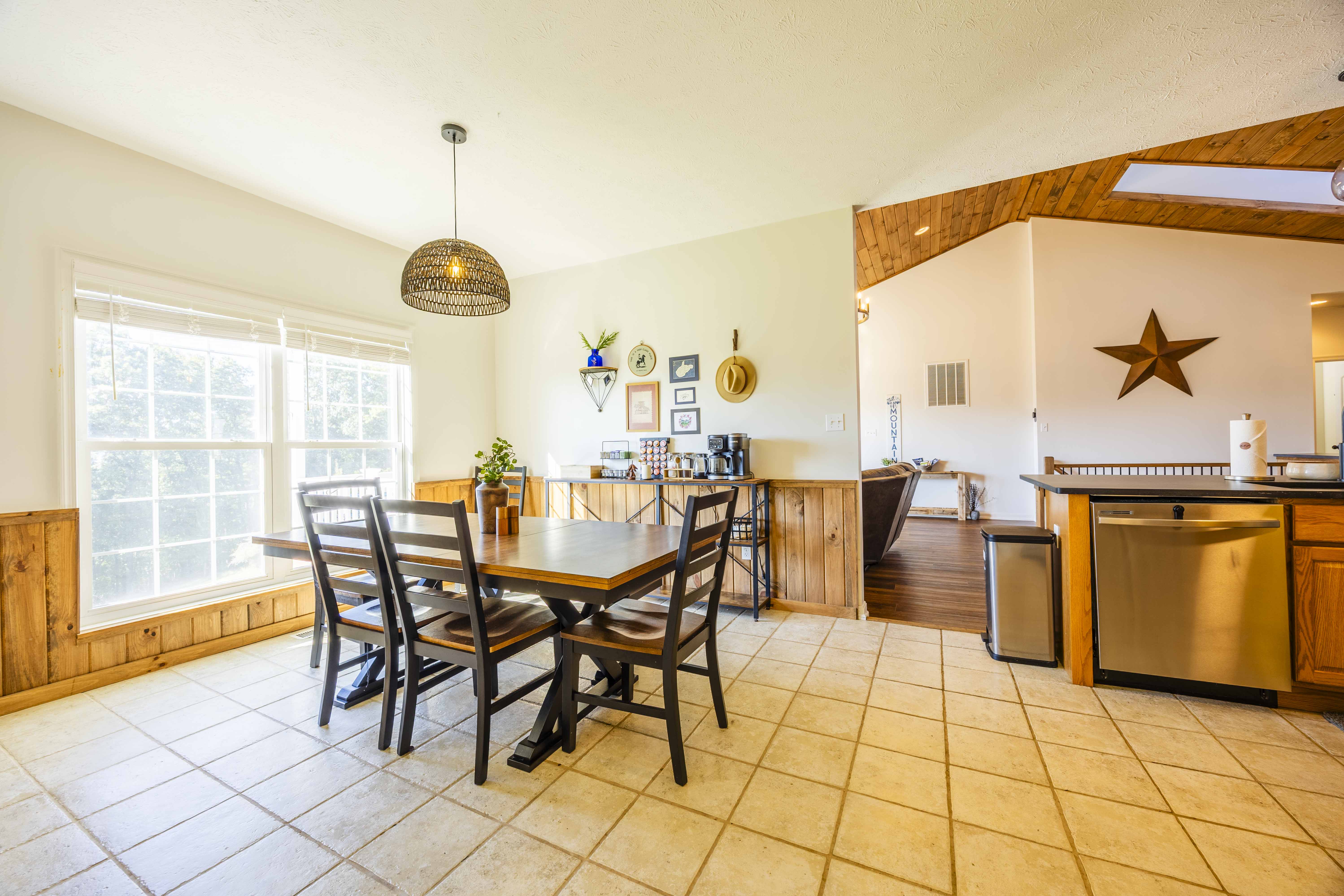 Bright dining area with big windows, cozy wood accents, and open flow