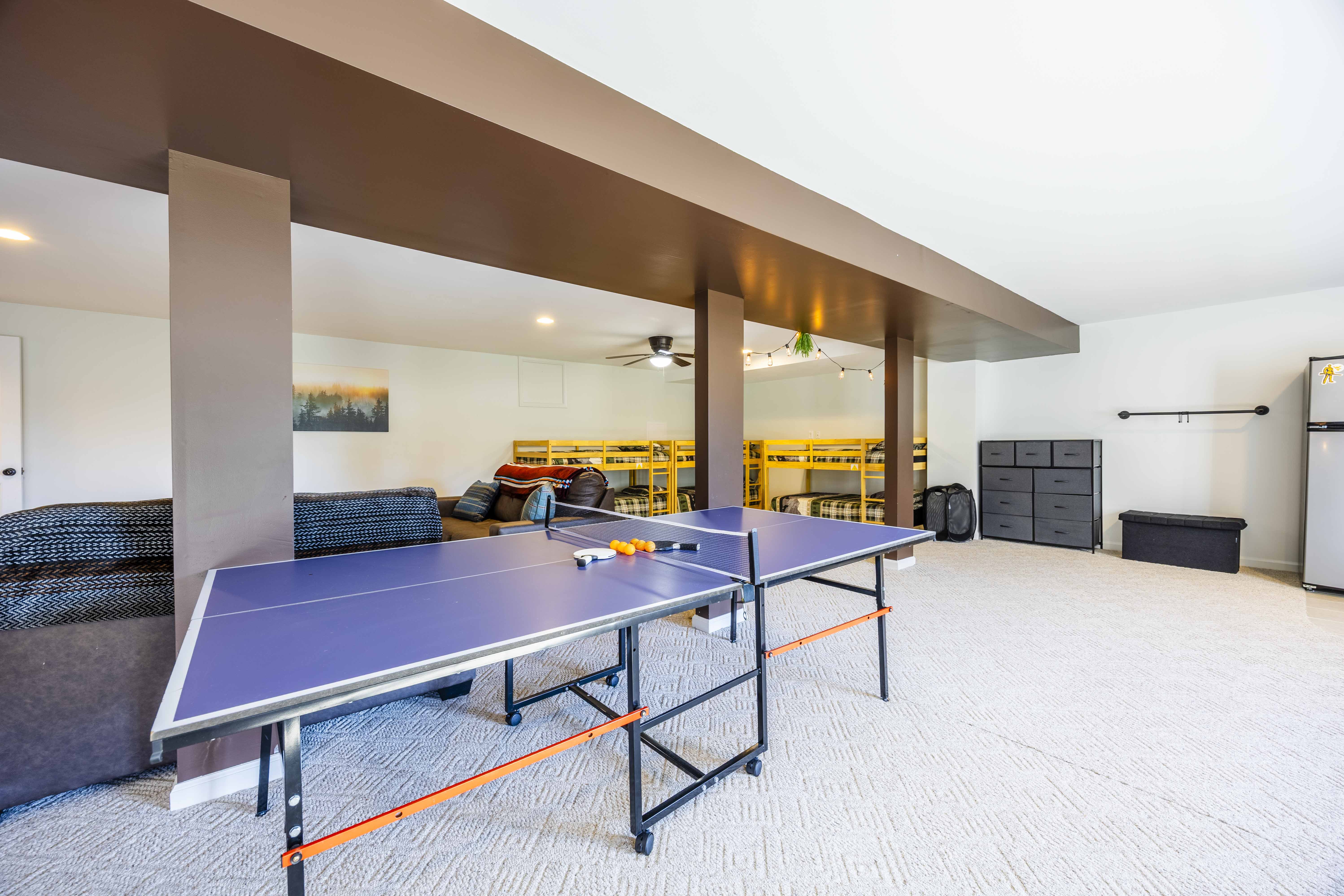Spacious game room with ping pong, lounge seating, and bunk beds