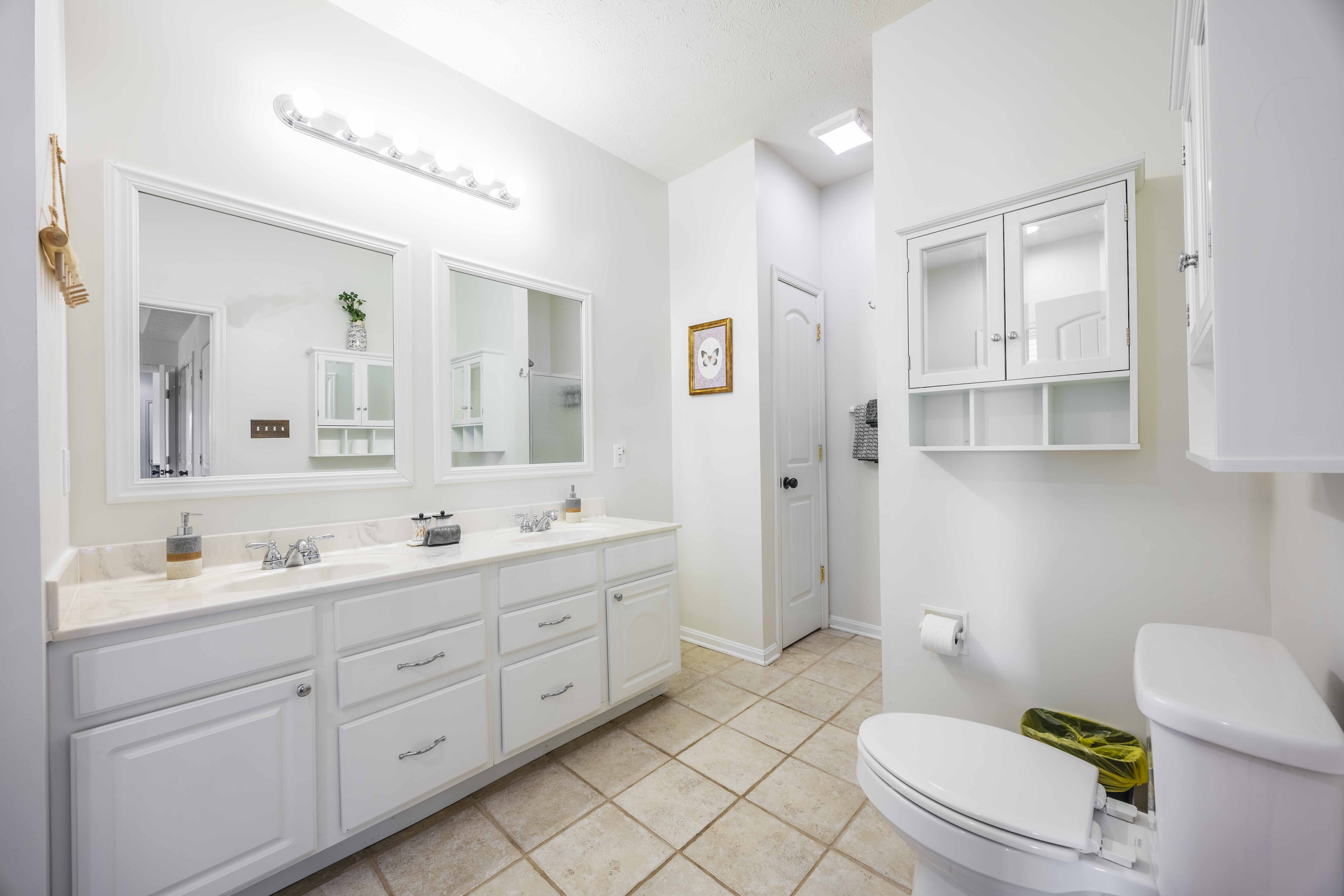 Bright double-vanity bathroom with ample storage and clean, modern style