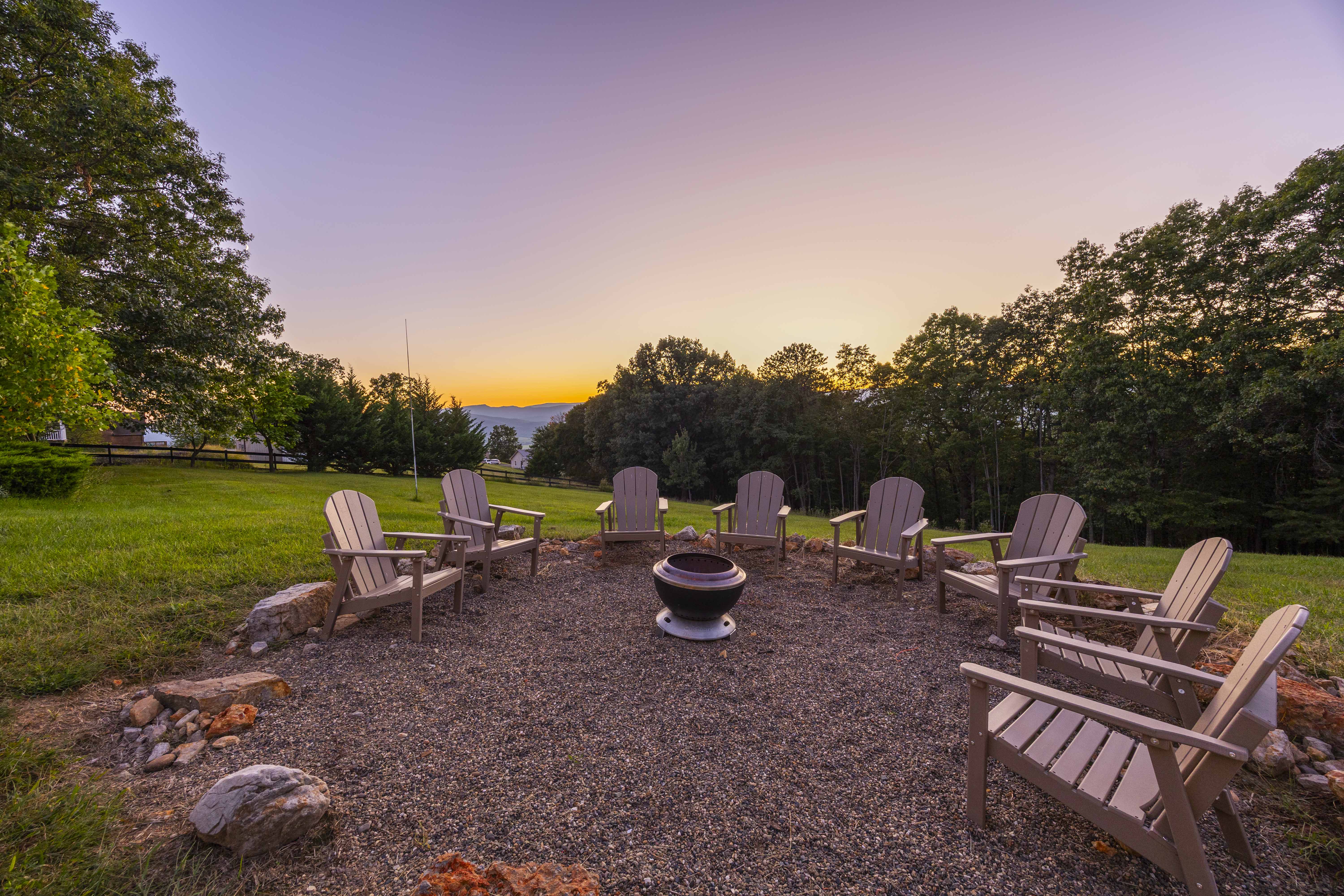 Sunset fire pit lounge with Adirondack chairs and peaceful wooded views