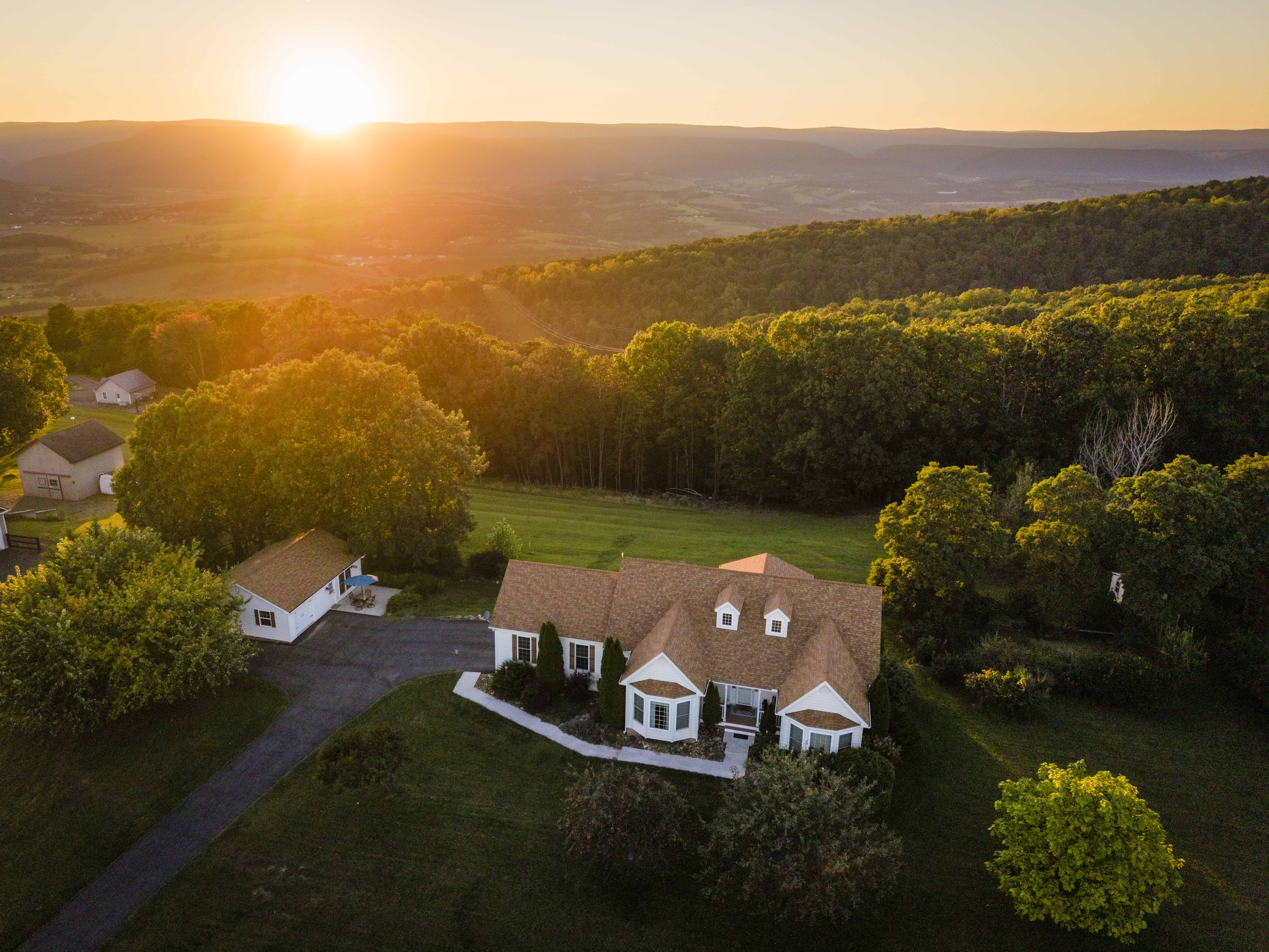 Peaceful hilltop home with sunset views and a private wooded setting