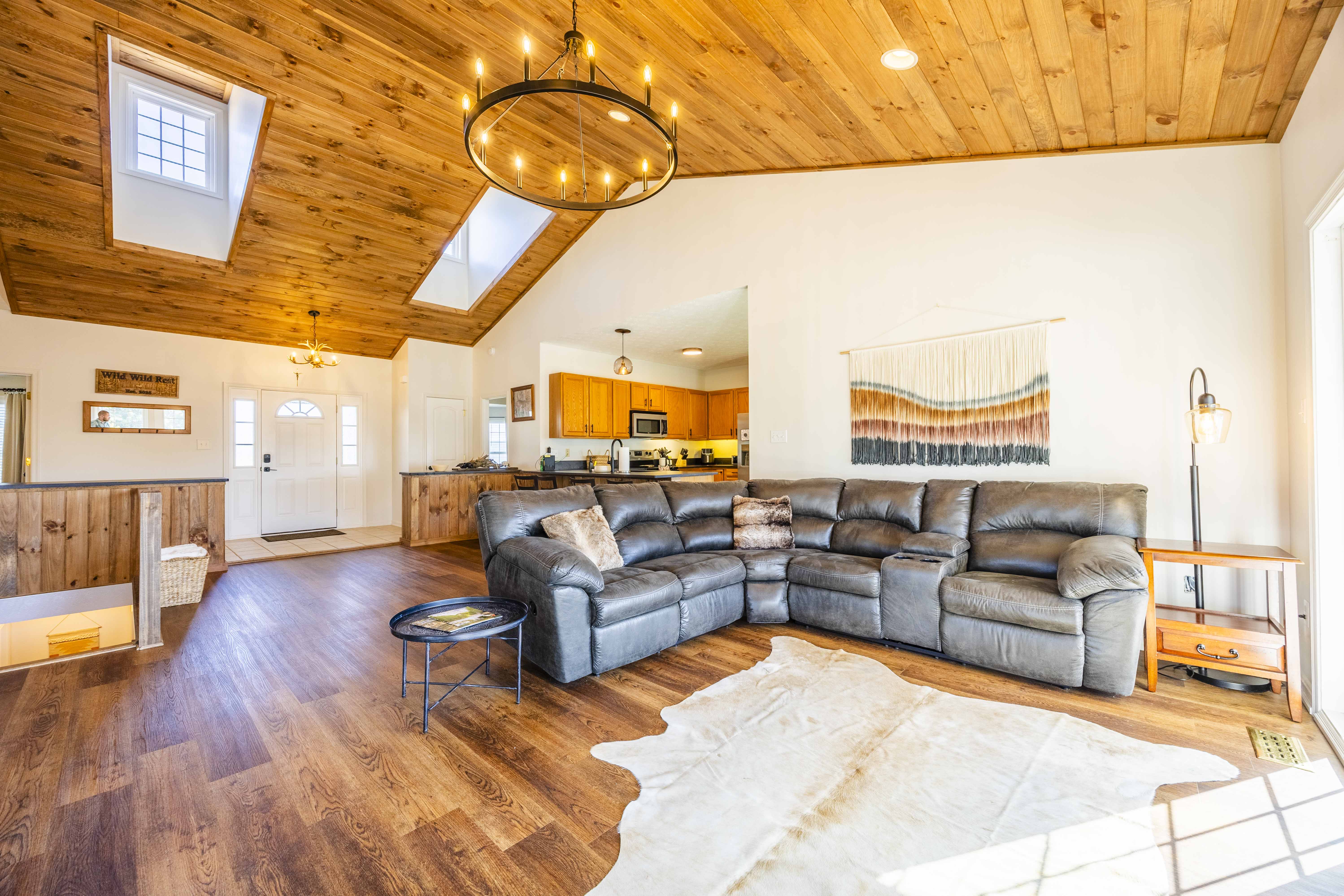 Bright great room with vaulted wood ceilings and a cozy sectional