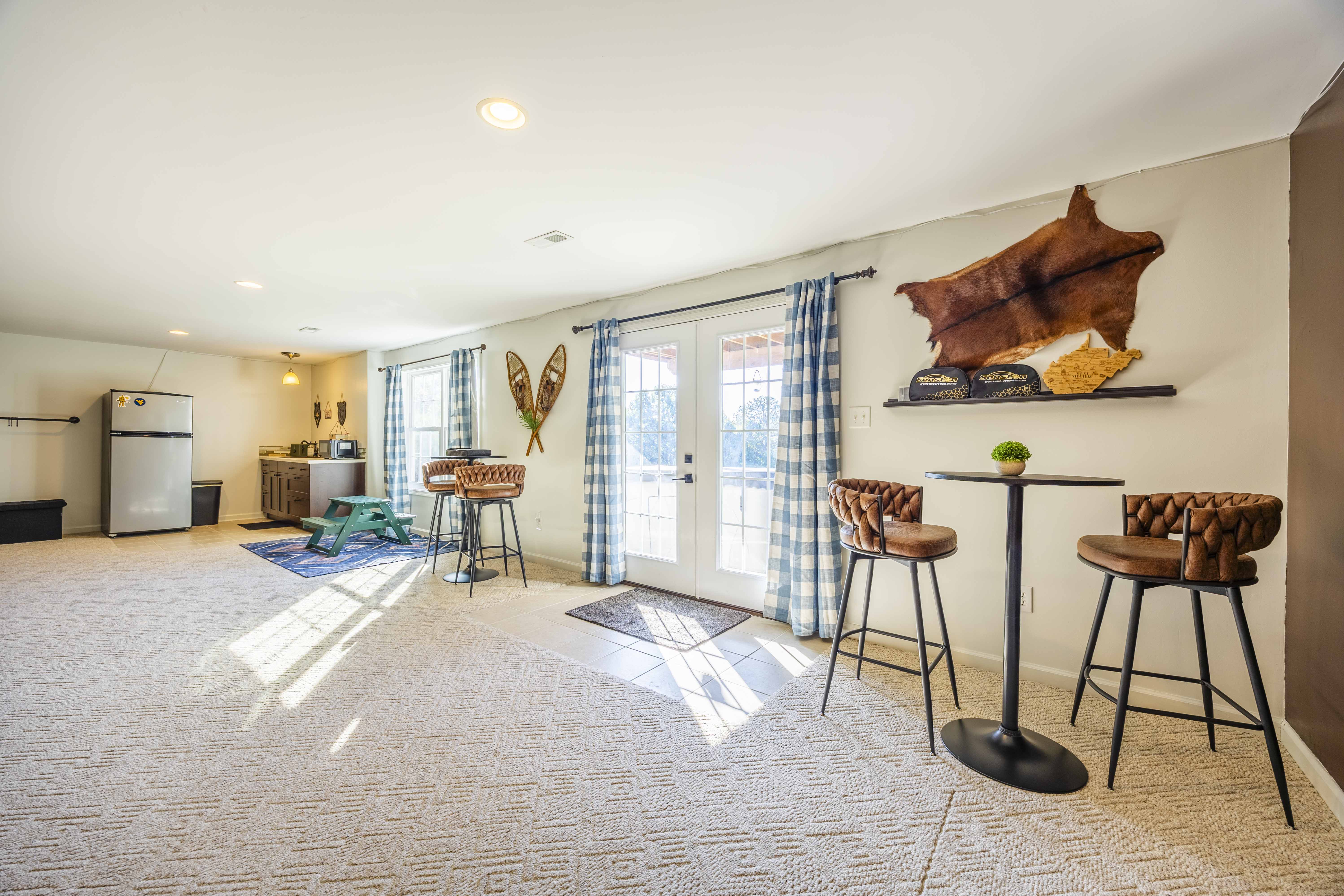 Bright bonus lounge with kitchenette, French doors, and cozy seating