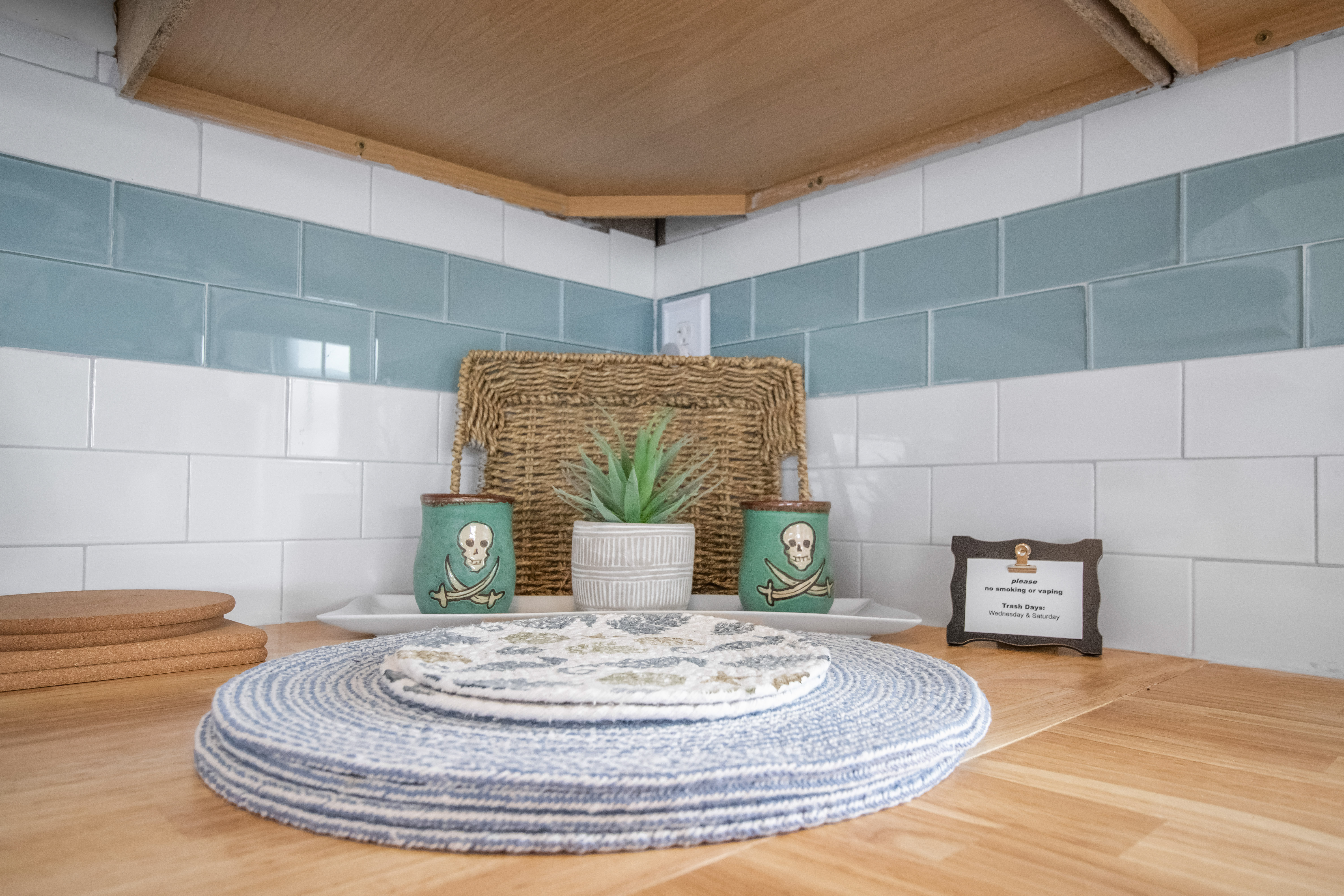 Charming coastal-style kitchen details with warm wood and fresh blue tile