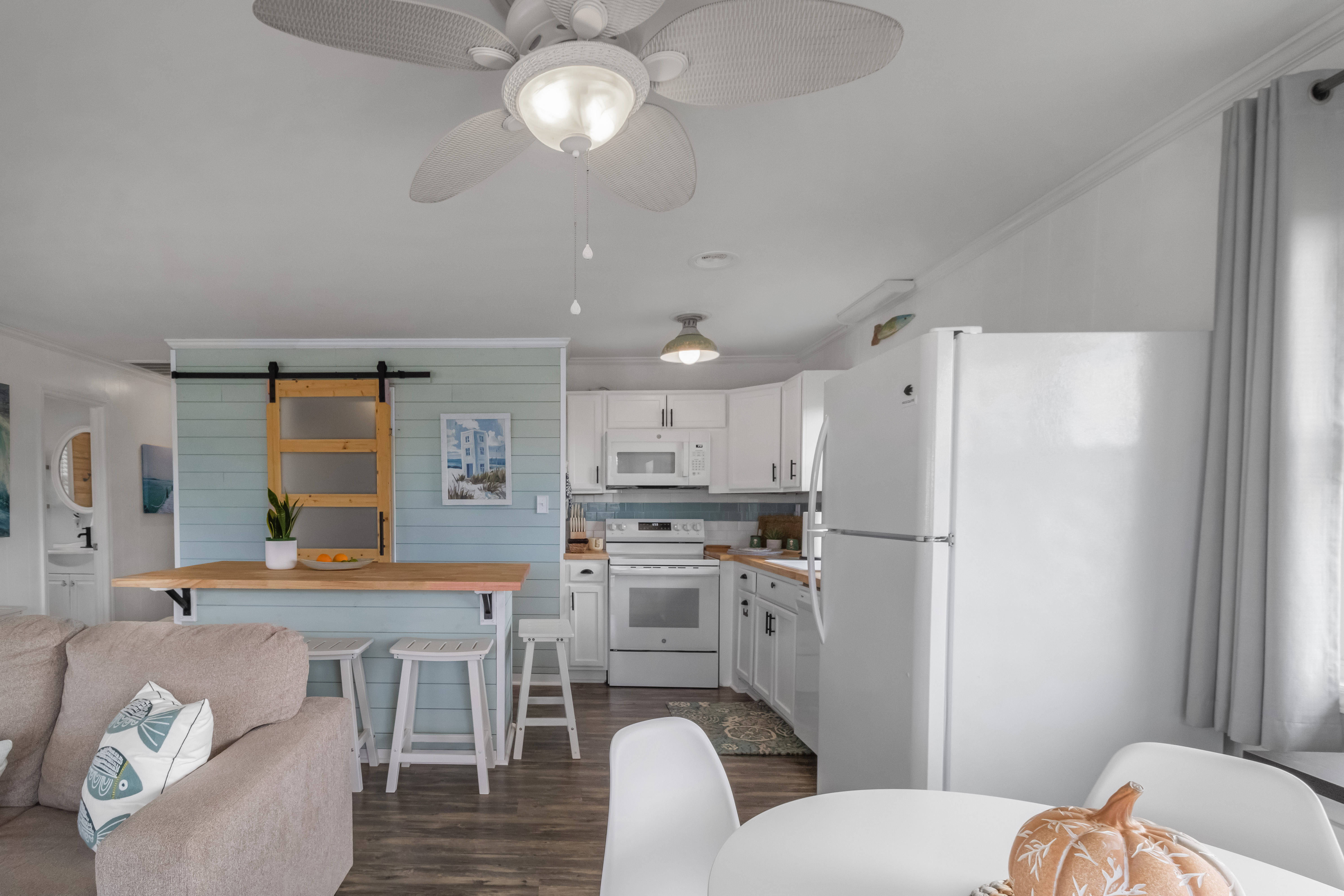Bright coastal kitchen with breakfast bar and airy open living space