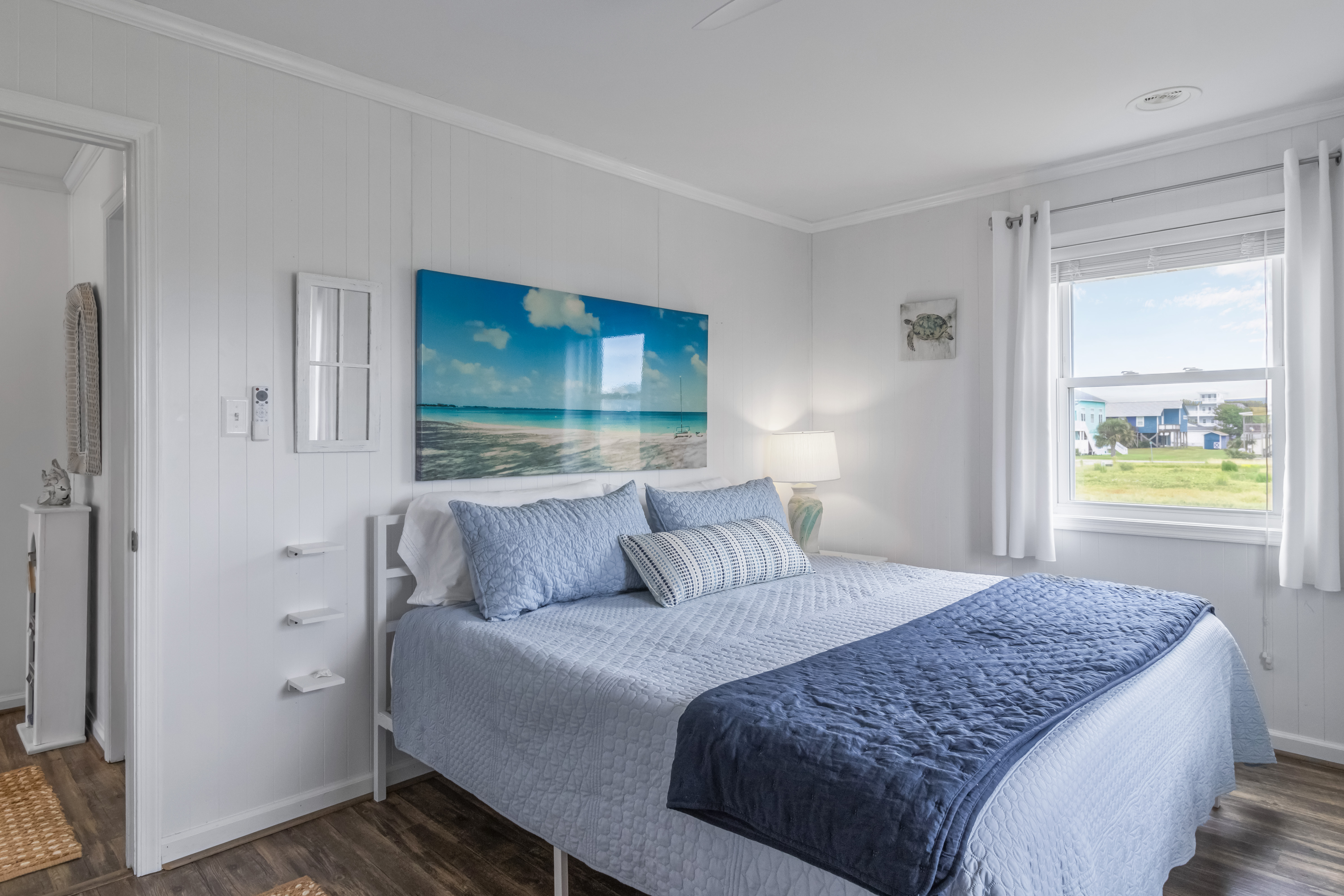 Bright coastal bedroom with serene beach decor and natural light