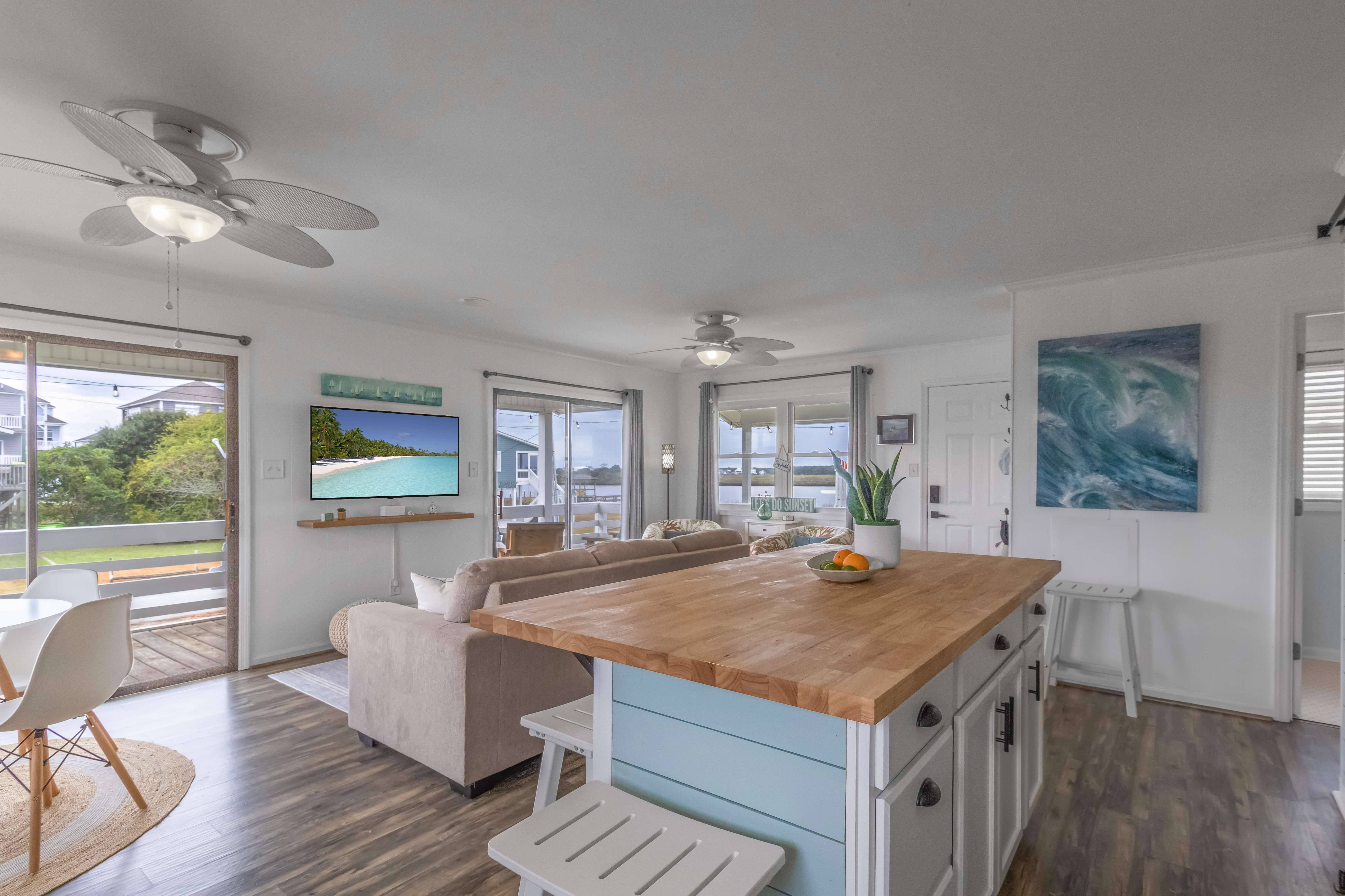 Bright coastal living space with large island and water views