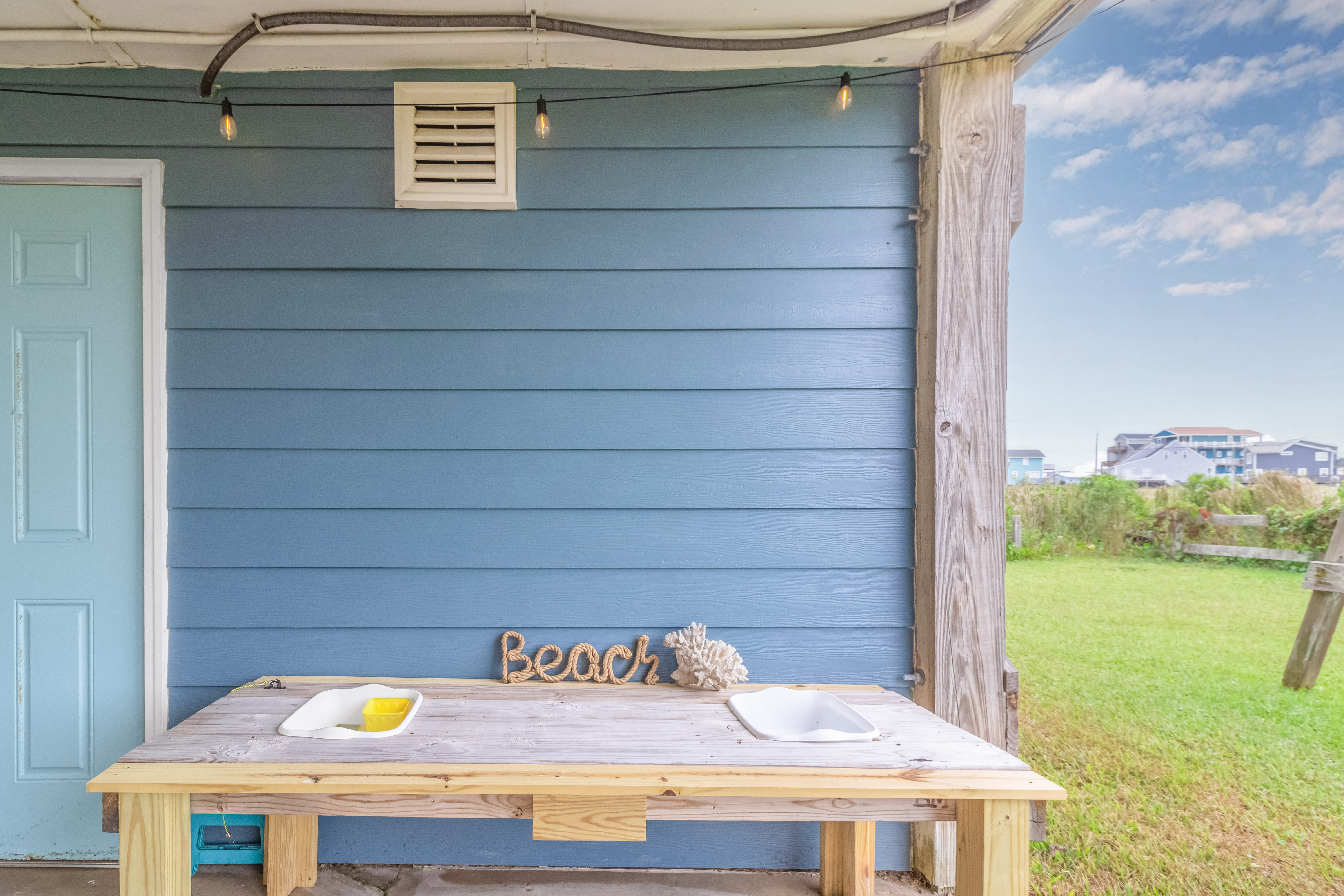 Covered outdoor space with beachy decor and a breezy coastal vibe