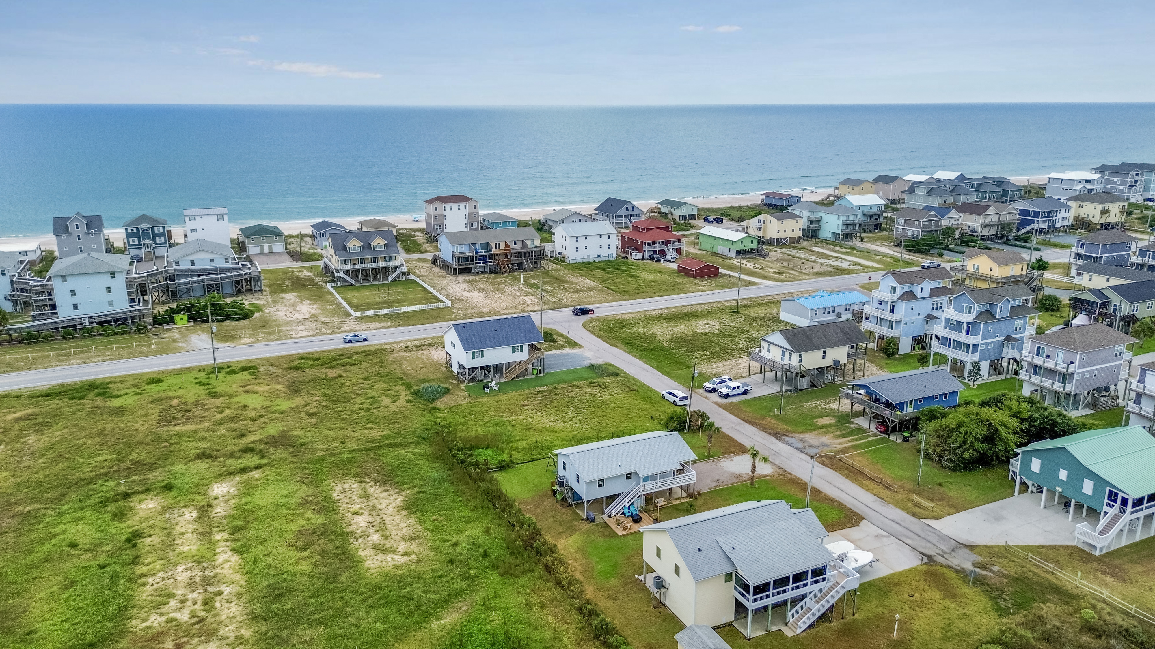 Aerial coastal retreat with beach access and sweeping ocean views
