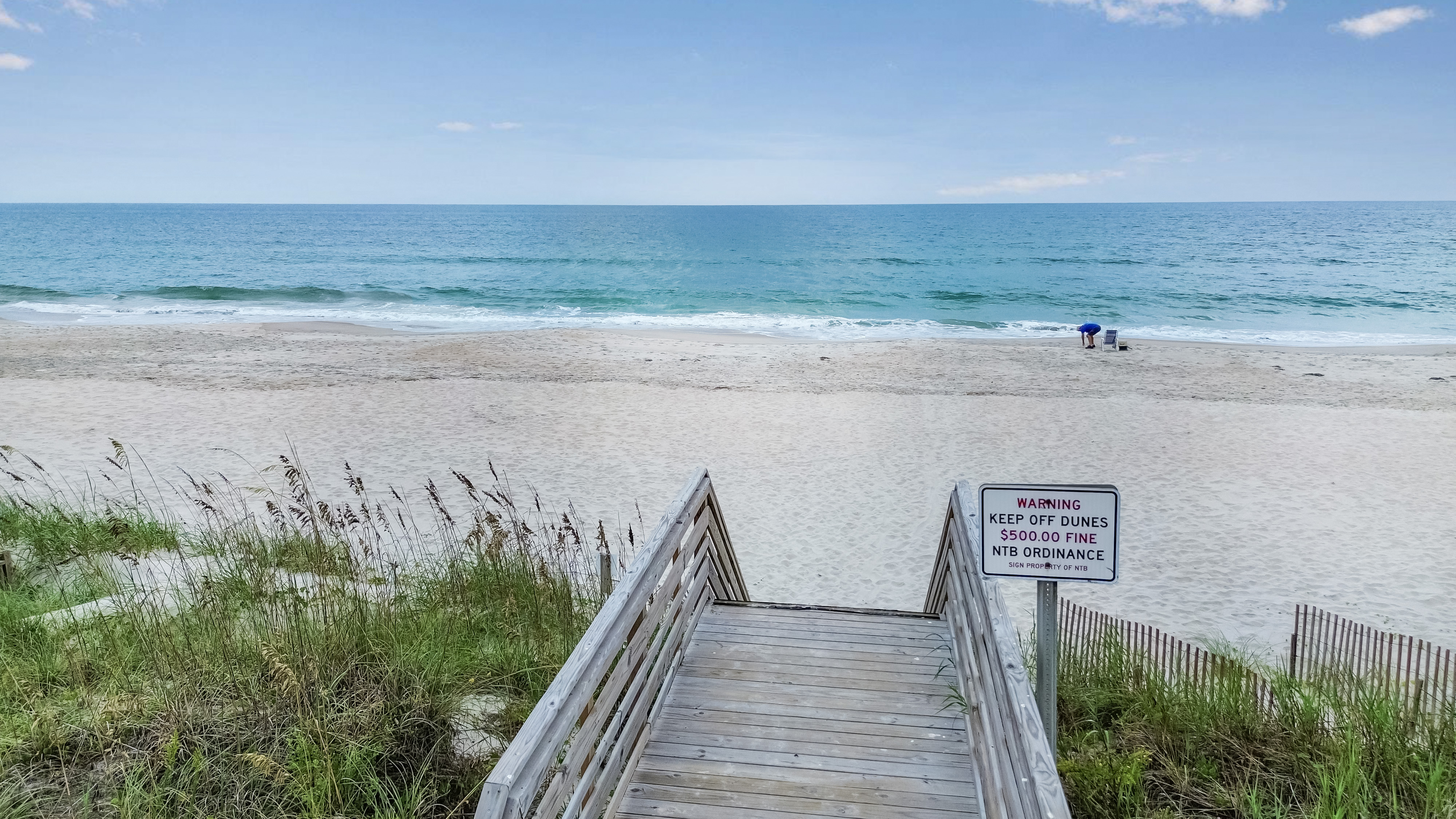 Private boardwalk to a serene white-sand beach and sparkling ocean views