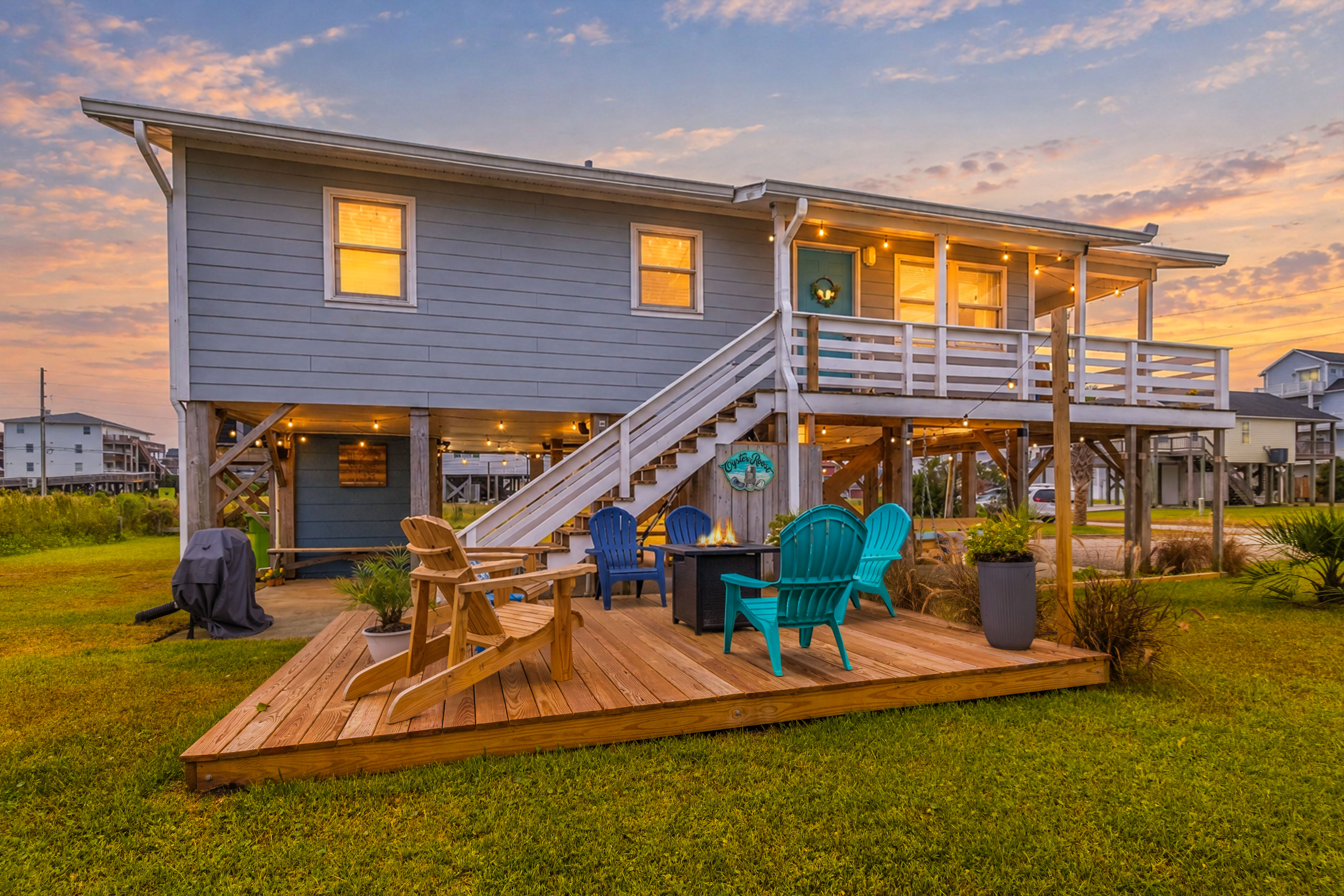 Sunset views and fire pit seating at this charming elevated beach house
