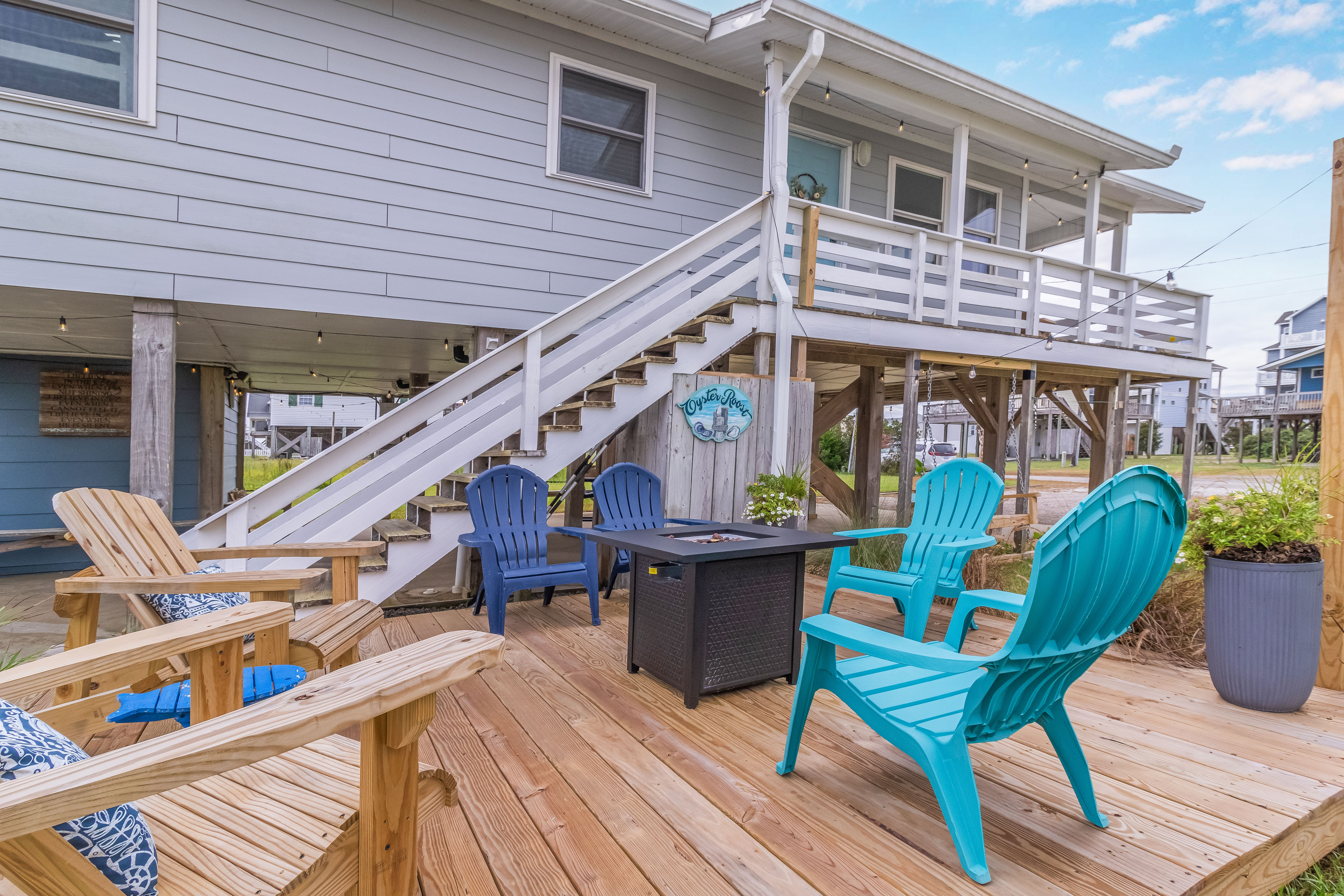 Relax on the breezy deck with Adirondack seating and a cozy fire pit