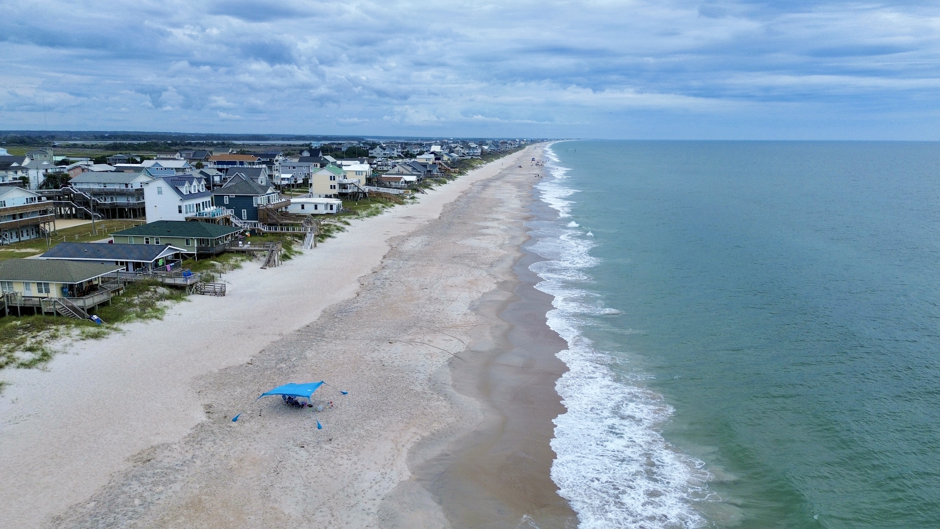 Wide sandy beach and sweeping ocean views just steps from the home