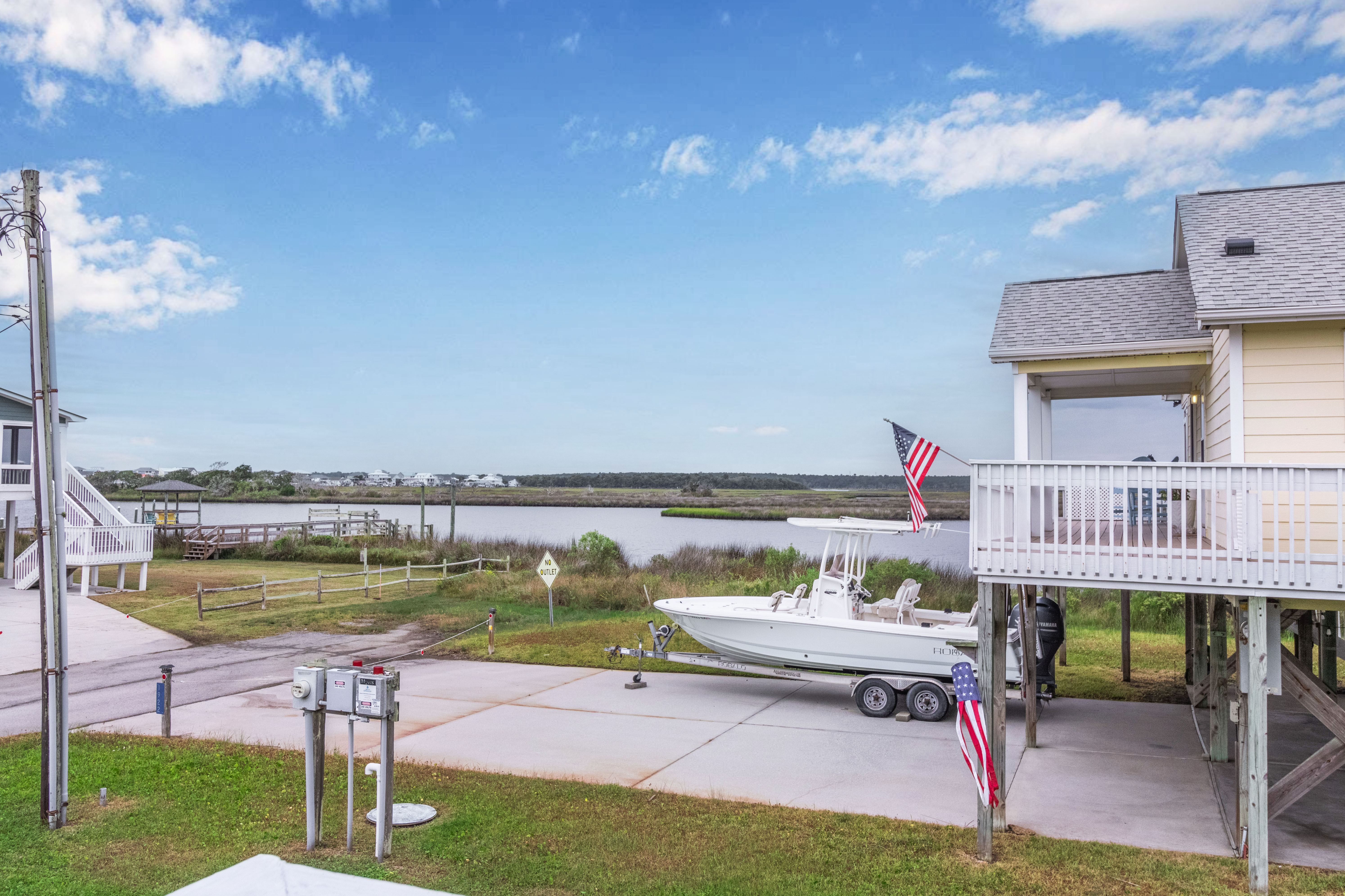 Waterfront coastal home with marsh views, deck, and boat-friendly access