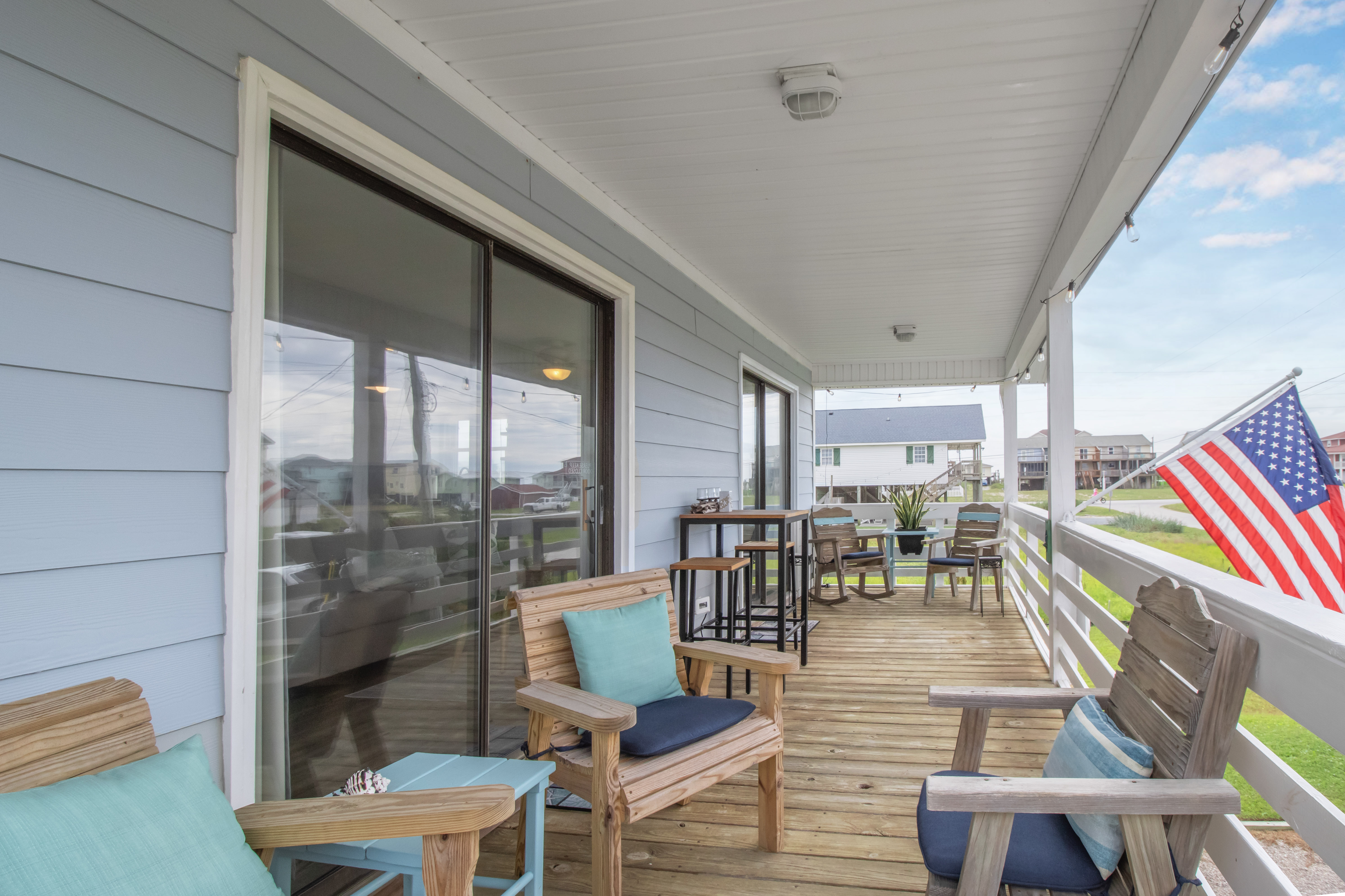 Spacious covered porch with comfy seating and relaxing outdoor dining